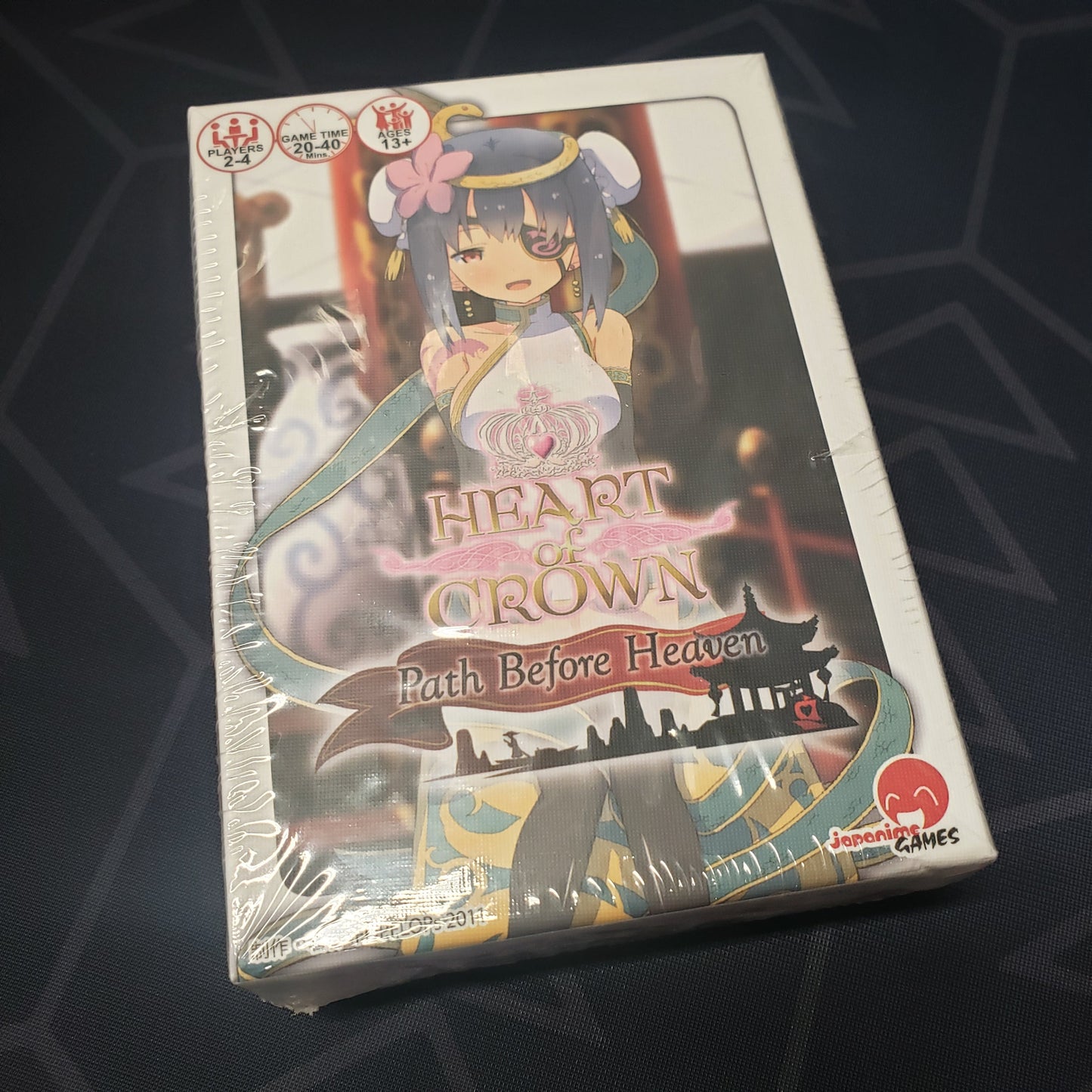 Image shows the front cover of the box of the Path Before Heaven expansion for the card game Heart of Crown
