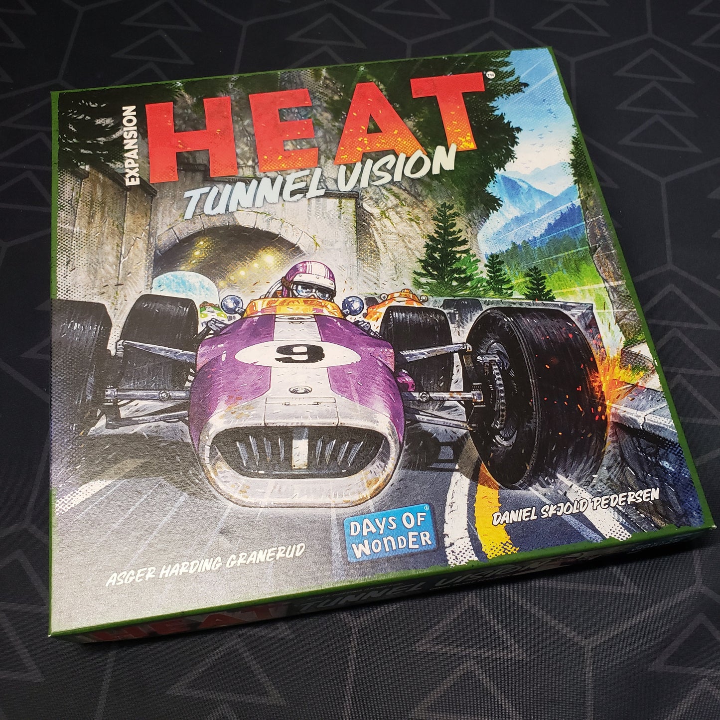 Image shows the front cover of the box of the Tunnel Vision expansion for the board game Heat