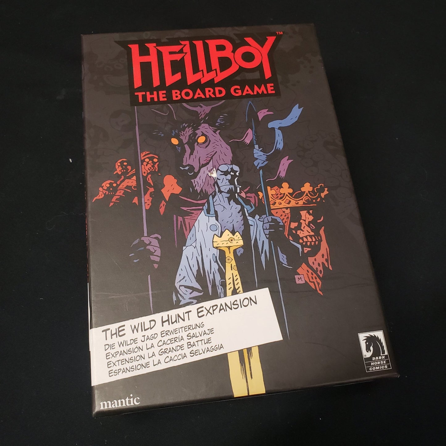 Image shows the front cover of the box of the Wild Hunt expansion for Hellboy: The Board Game