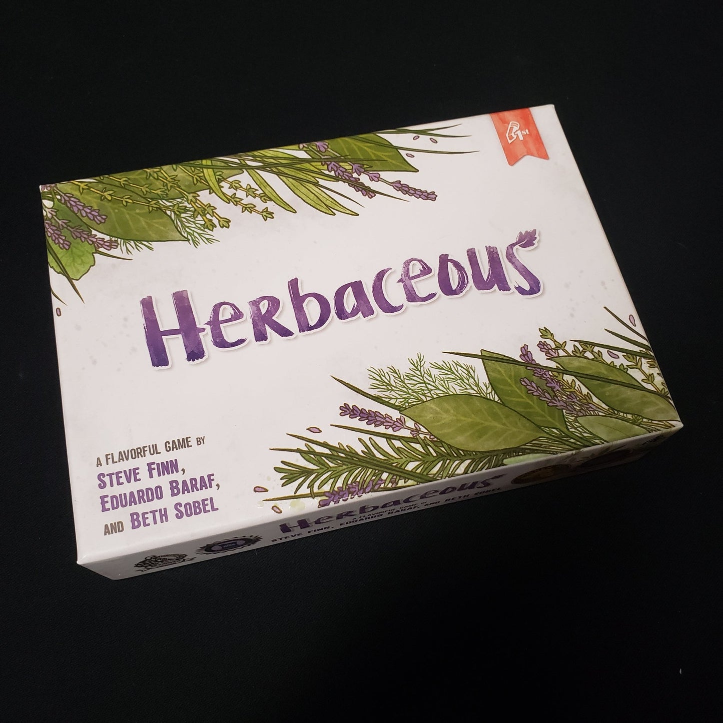 Image shows the front cover of the box of the Herbaceous card game
