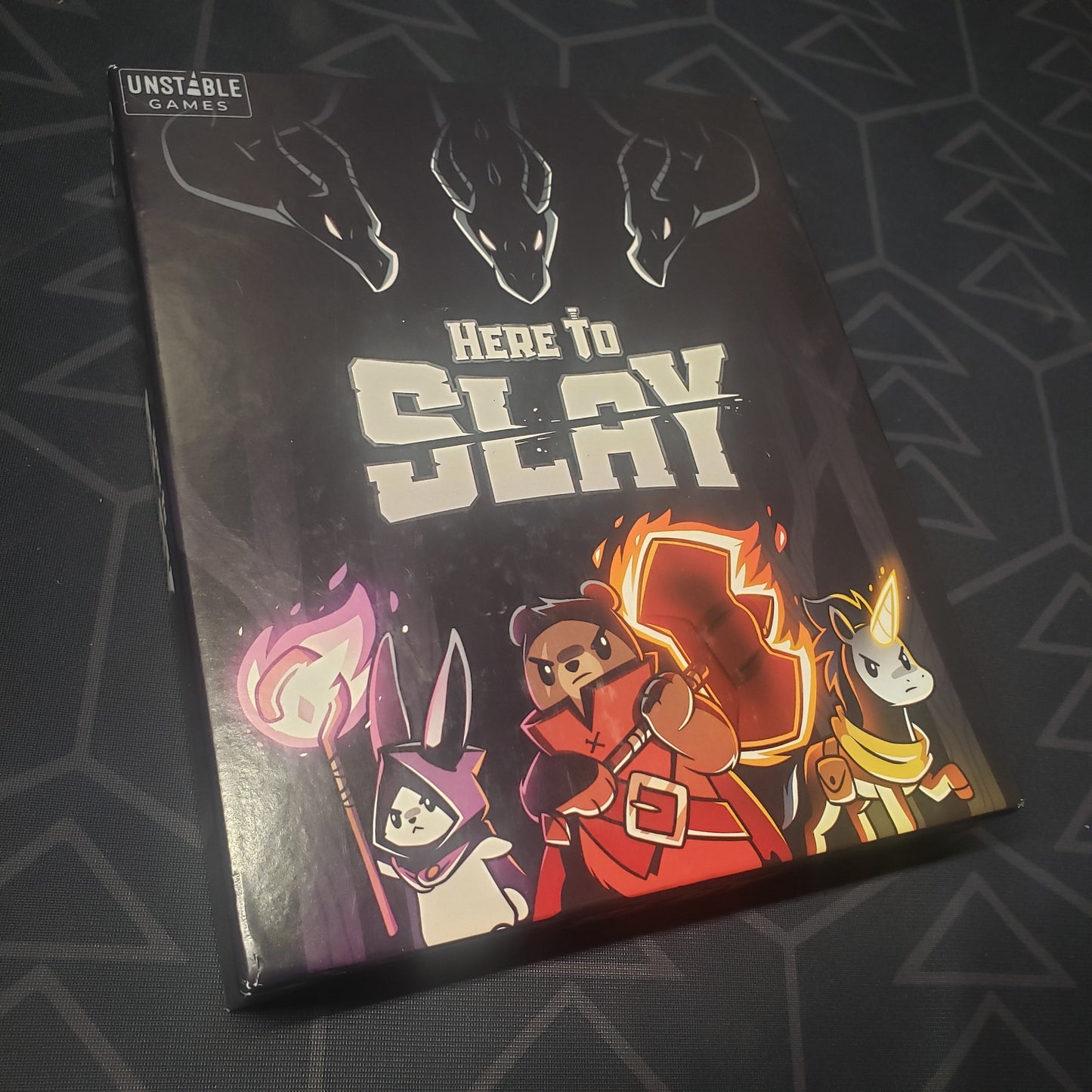 Image shows the front cover of the box for the Here to Slay (Retail Edition) card game