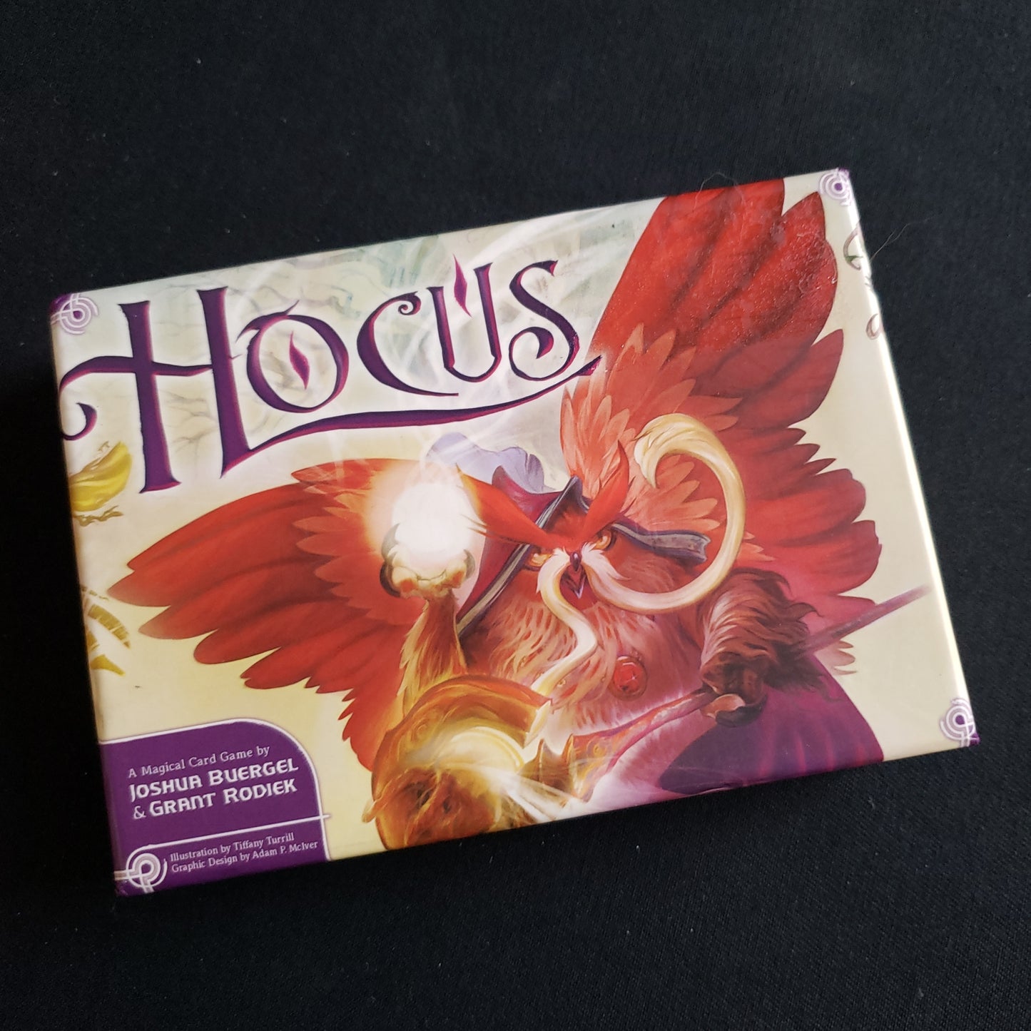 Image shows the front cover of the box of the Hocus card game