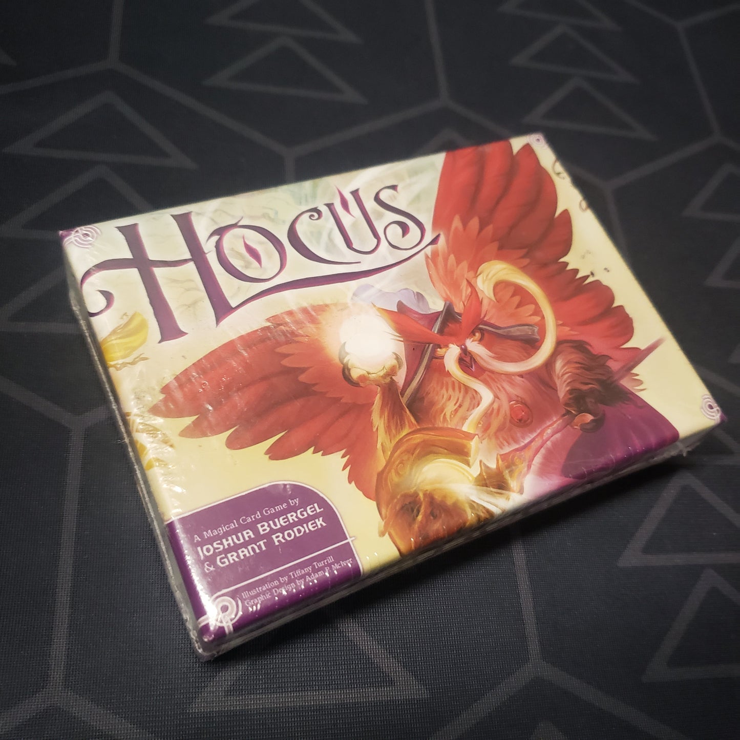 Image shows the front cover of the box of the Hocus card game