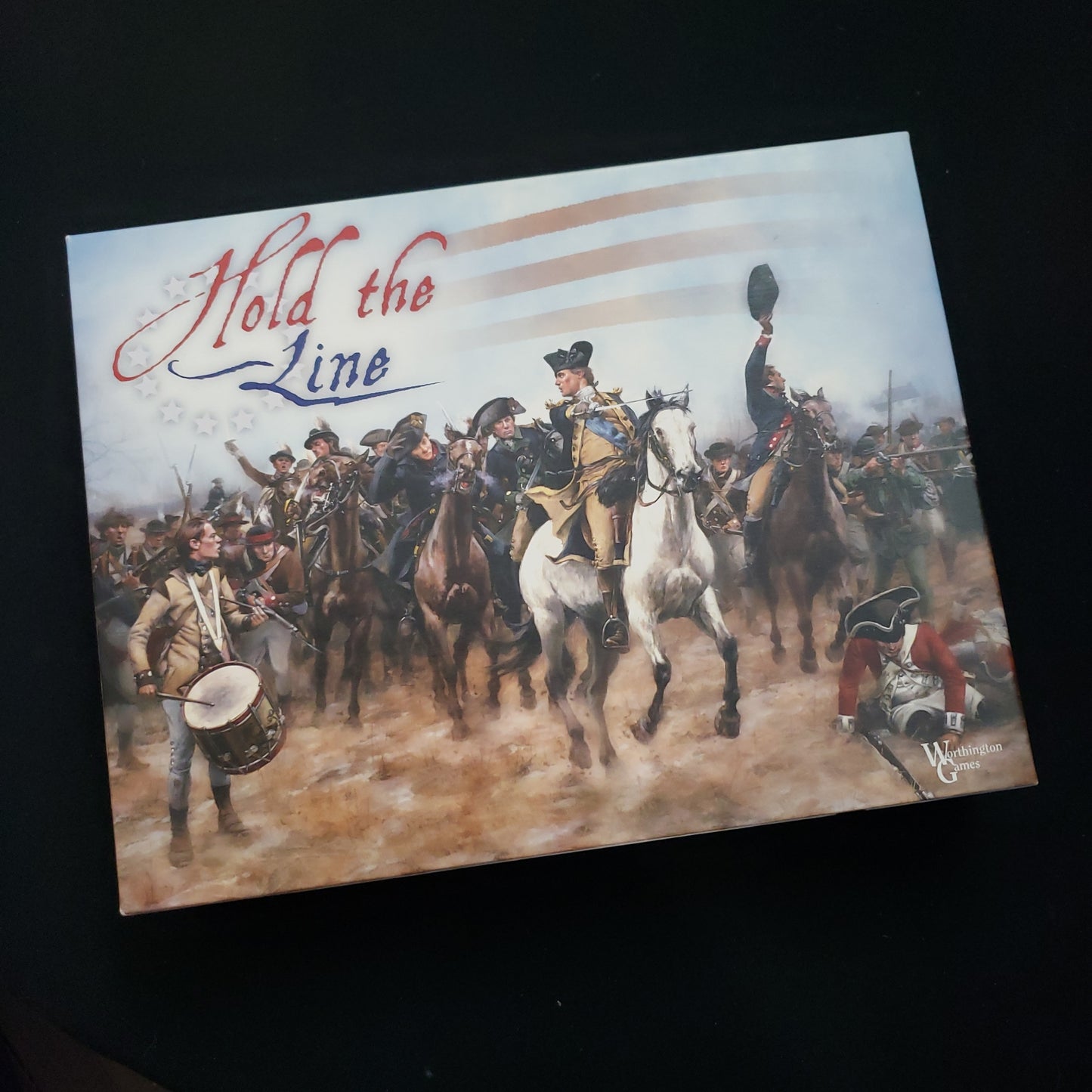 Image shows the front cover of the box of the Hold the Line board game