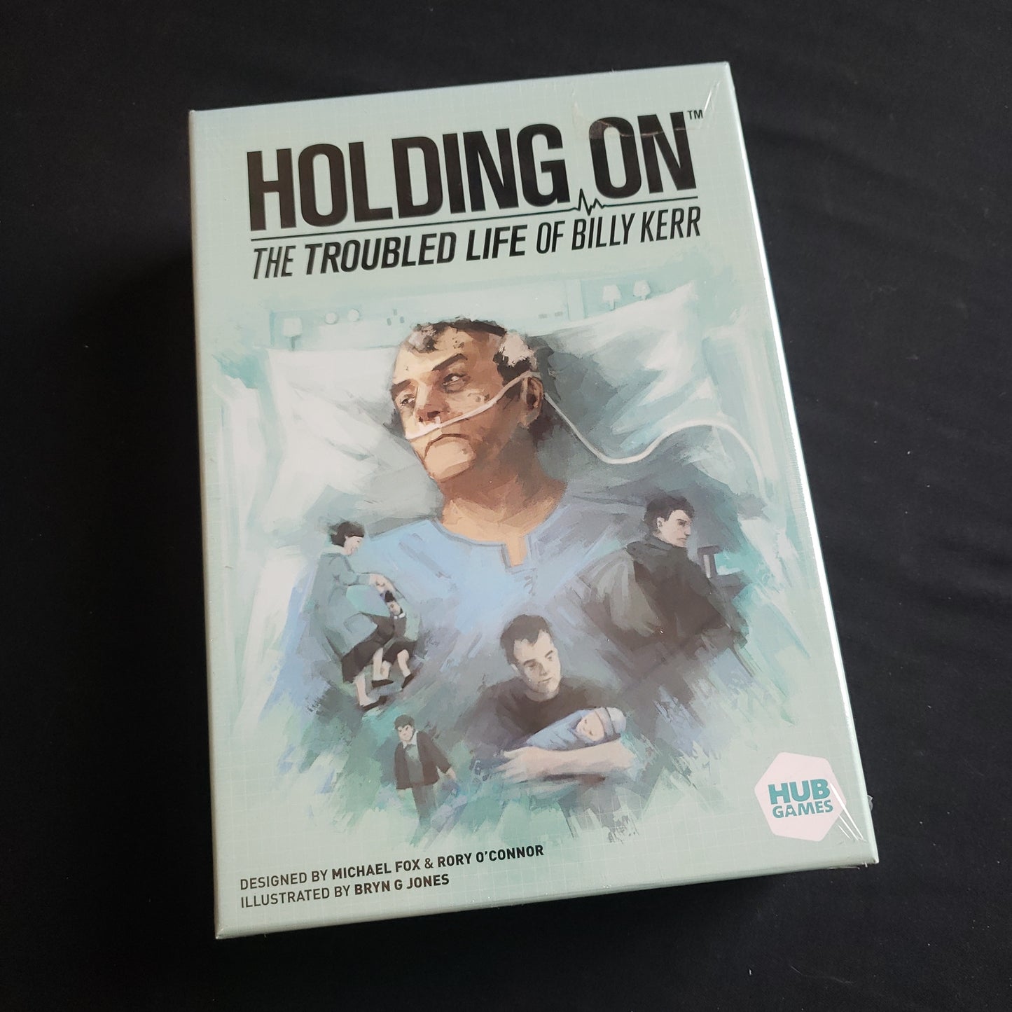 Image shows the front cover of the box of the Holding On: The Troubled Life of Billy Kerr board game