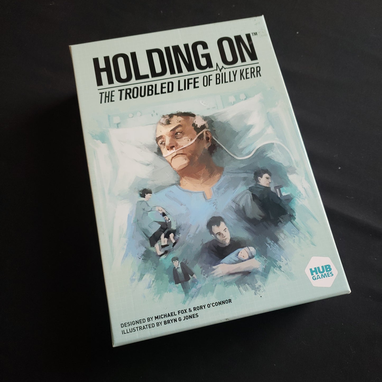 Image shows the front cover of the box of the Holding On: The Troubled Life of Billy Kerr board game