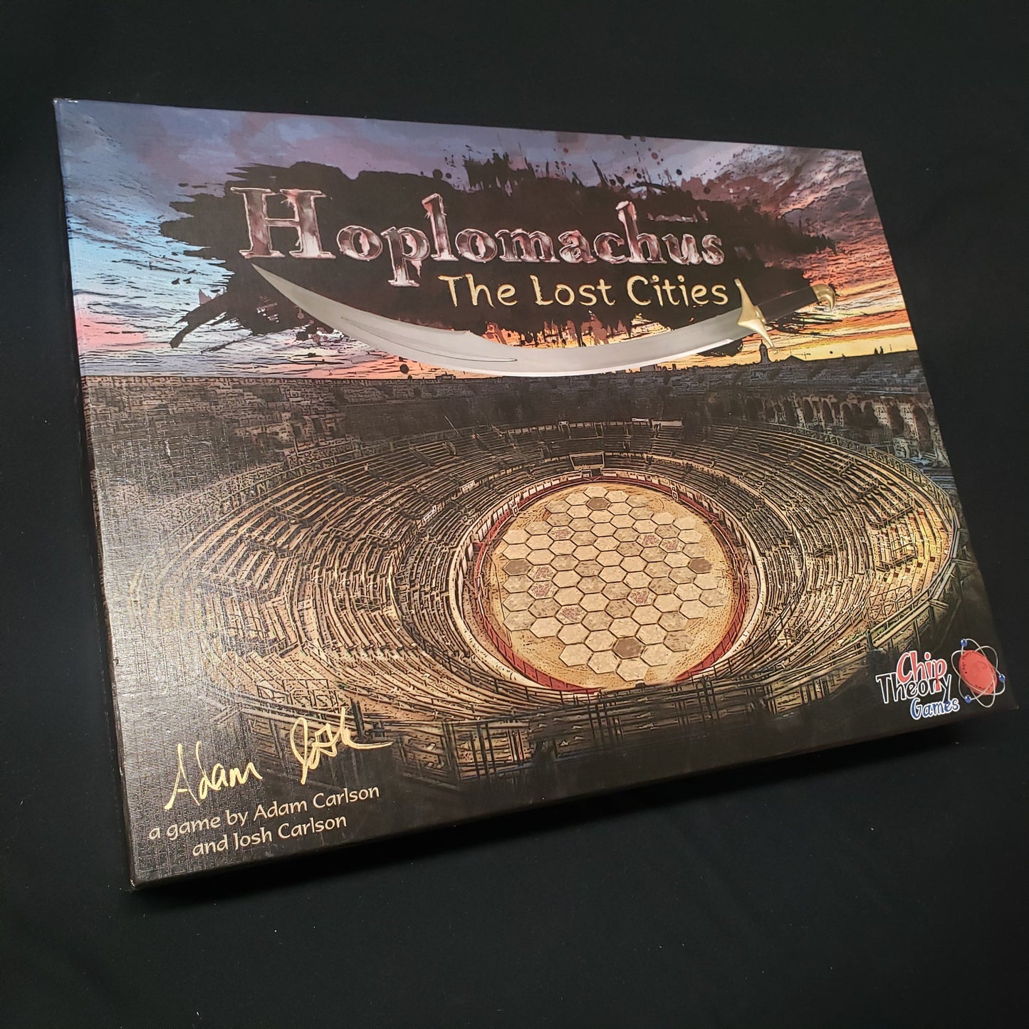 Image shows the front cover of the box of the Hoplomachus: The Lost Cities board game