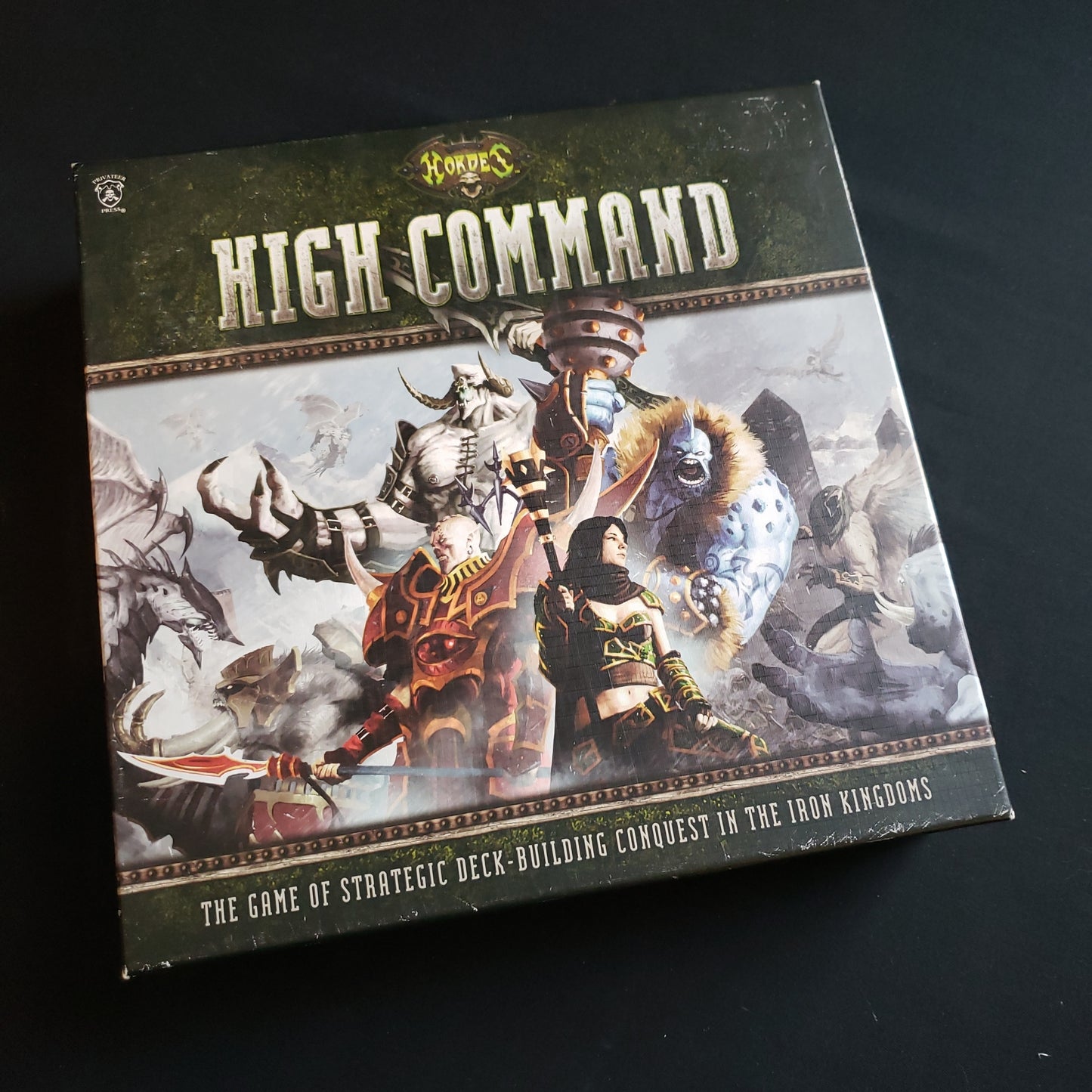Image shows the front cover of the box of the Hordes: High Command board game