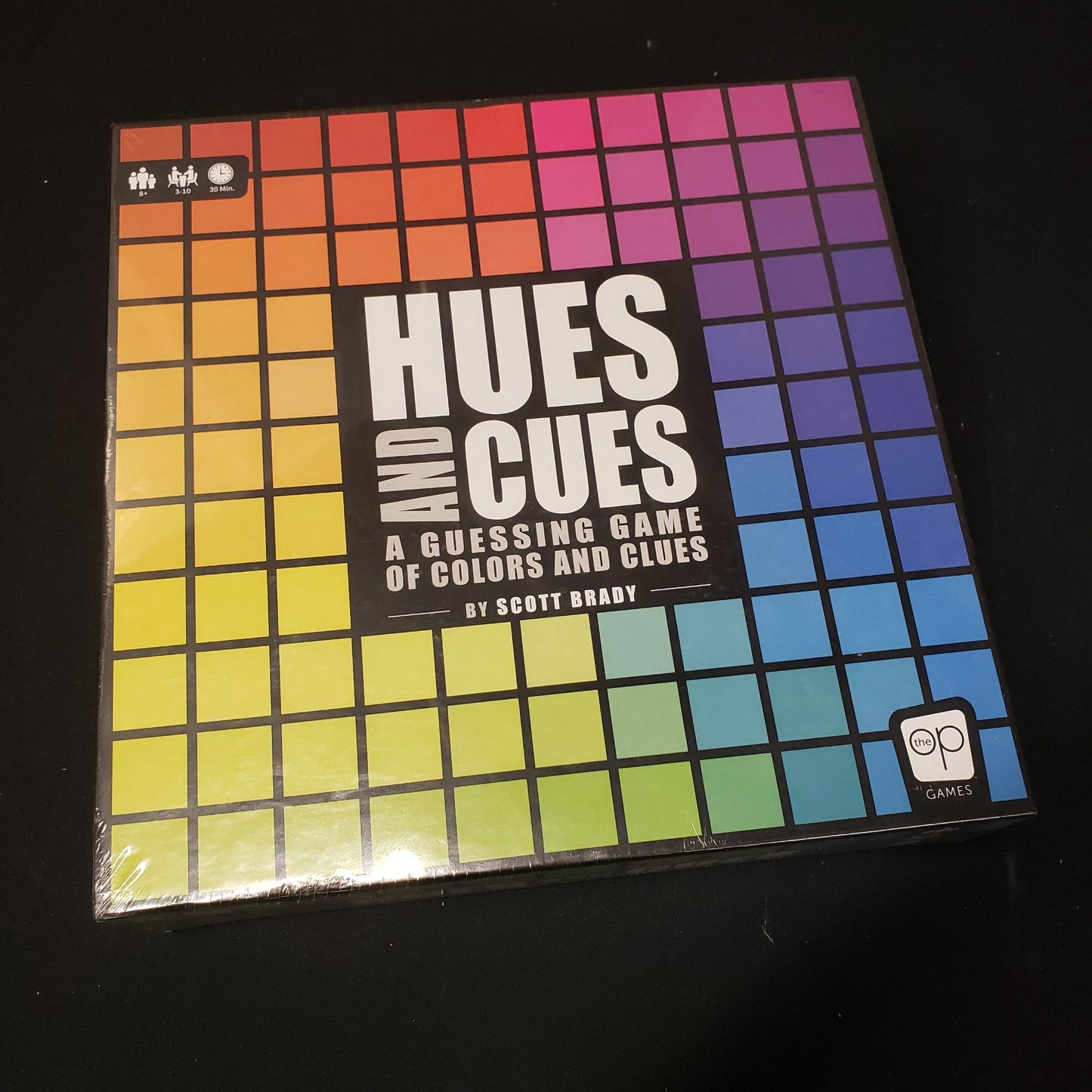 Image shows the front cover of the box of the Hues and Cues board game