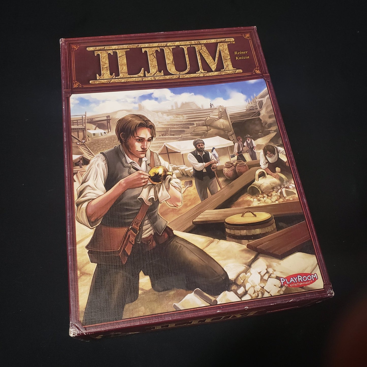 Image shows the front cover of the box of the Ilium board game