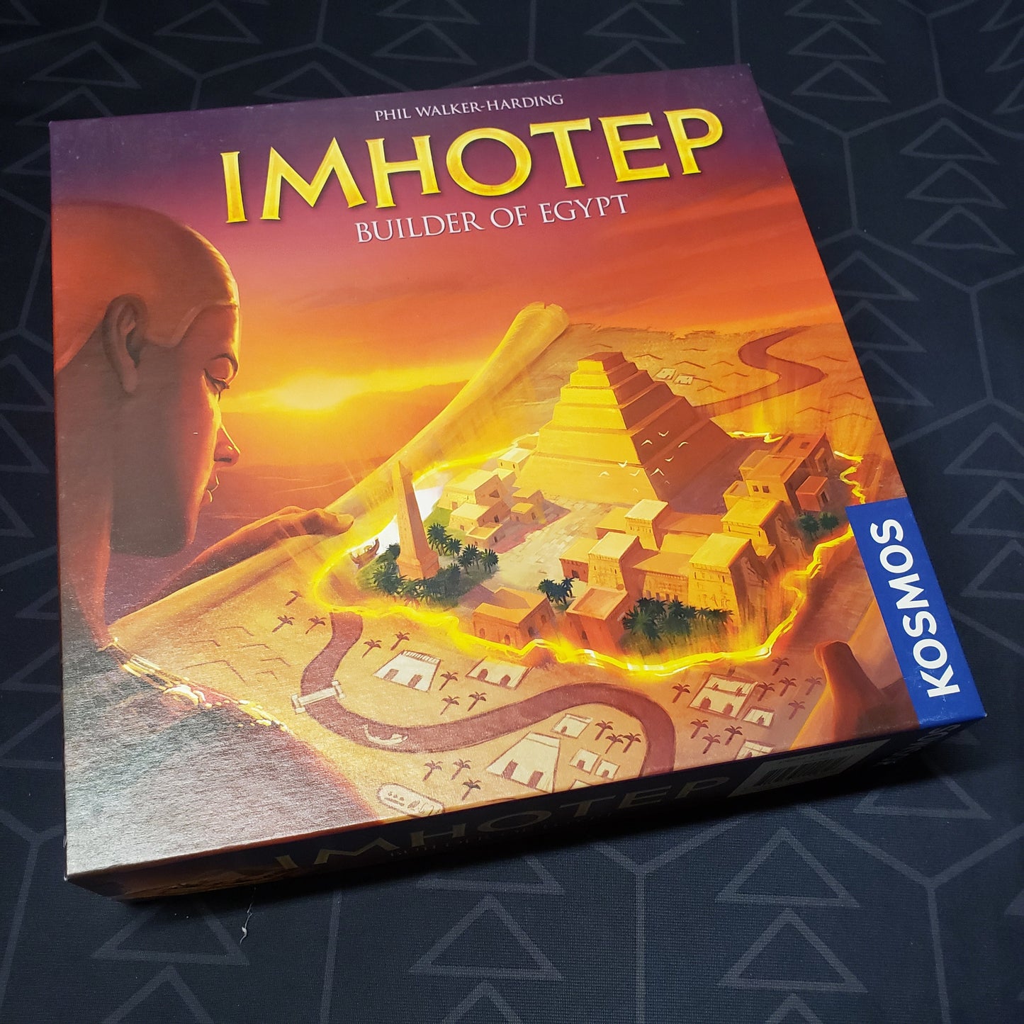 Image shows the front cover of the box of the Imhotep board game