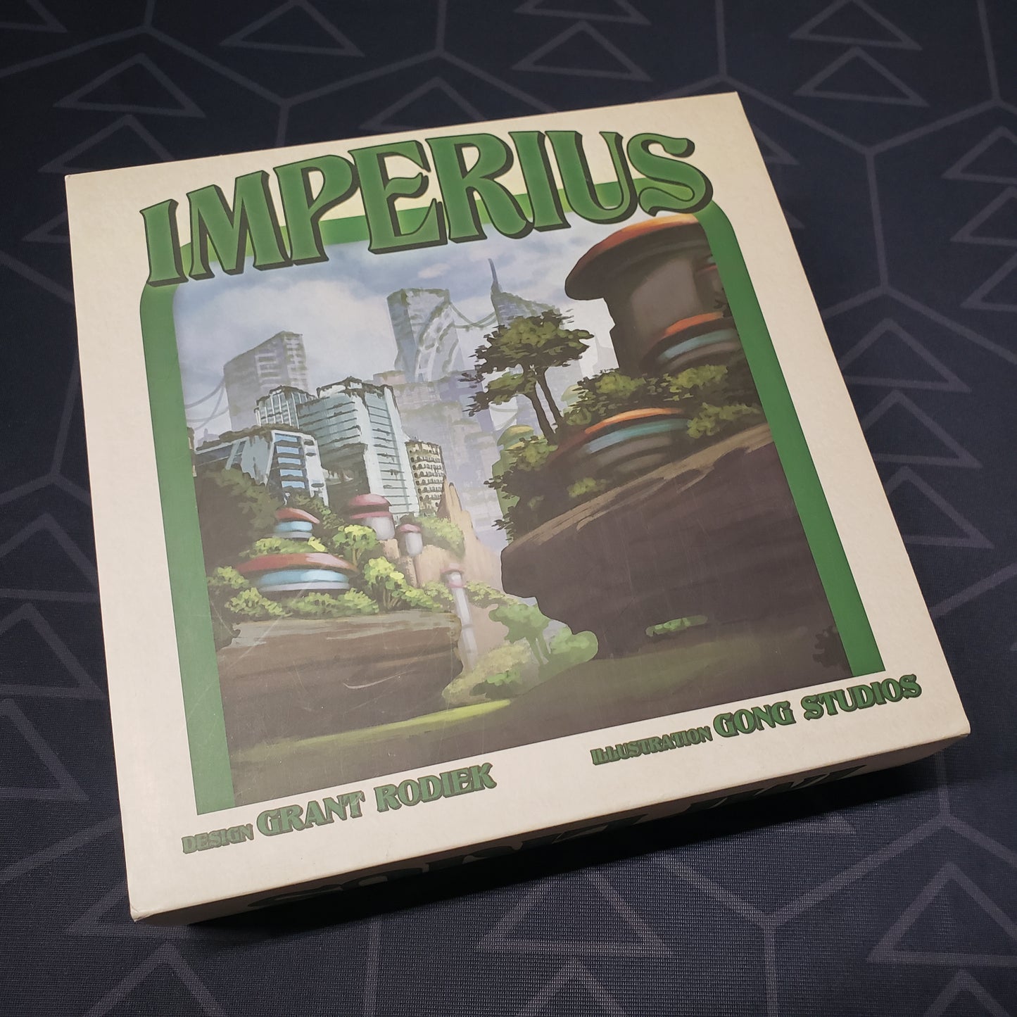 Image shows the front cover of the box of the Imperius card game