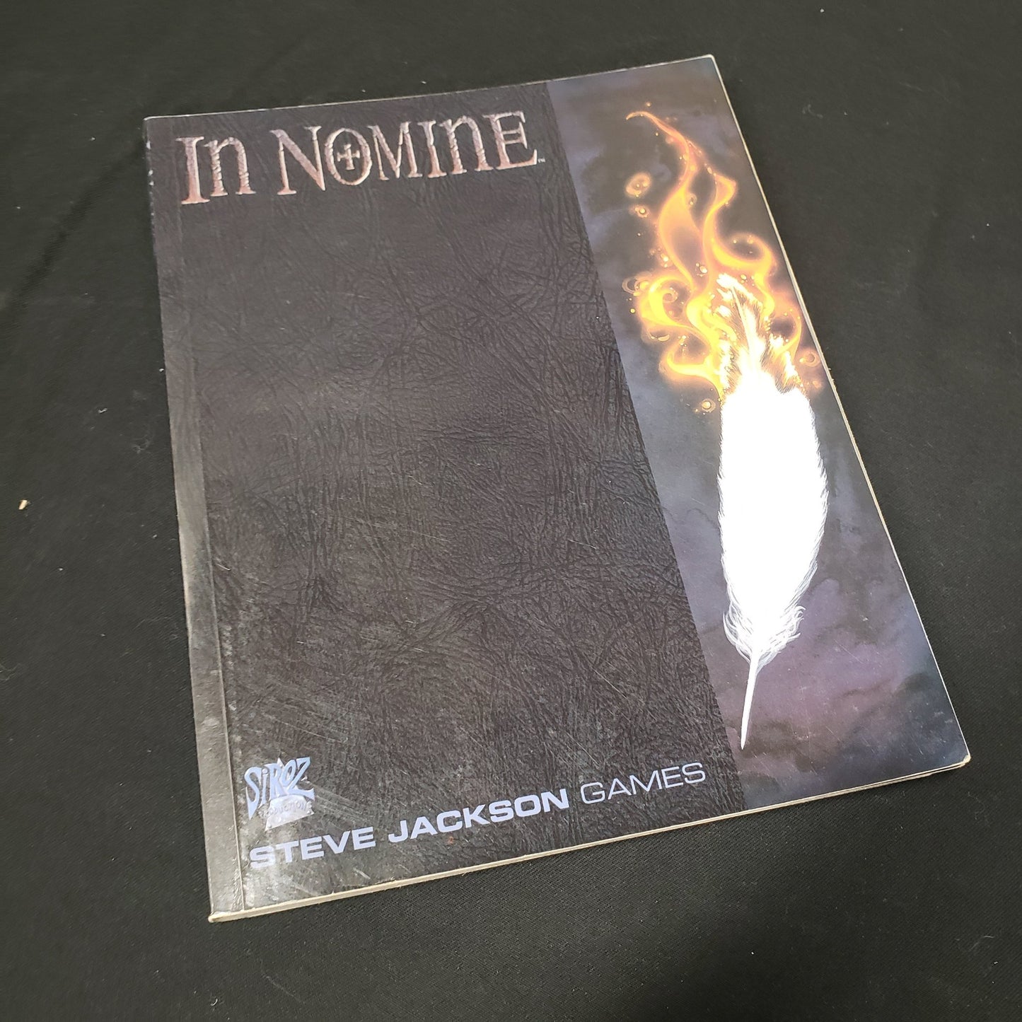 Image shows the front cover of the core rulebook for the roleplaying game In Nomine