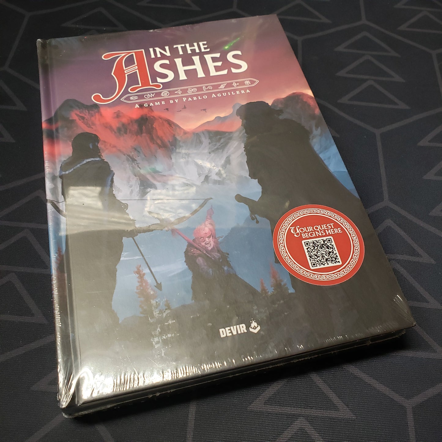Image shows the front cover of the In The Ashes roleplaying game book