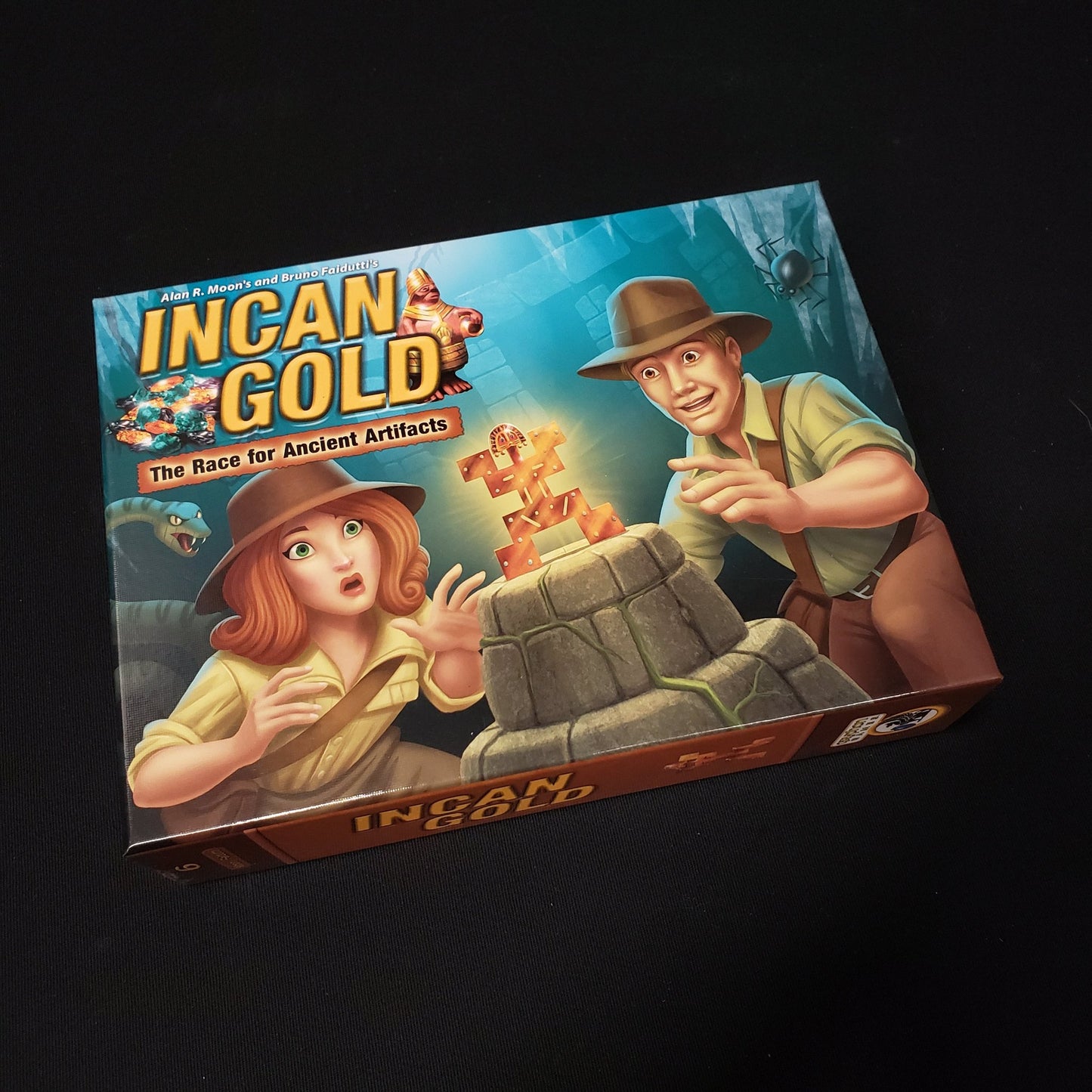 Image shows the front cover of the box of the Incan Gold board game