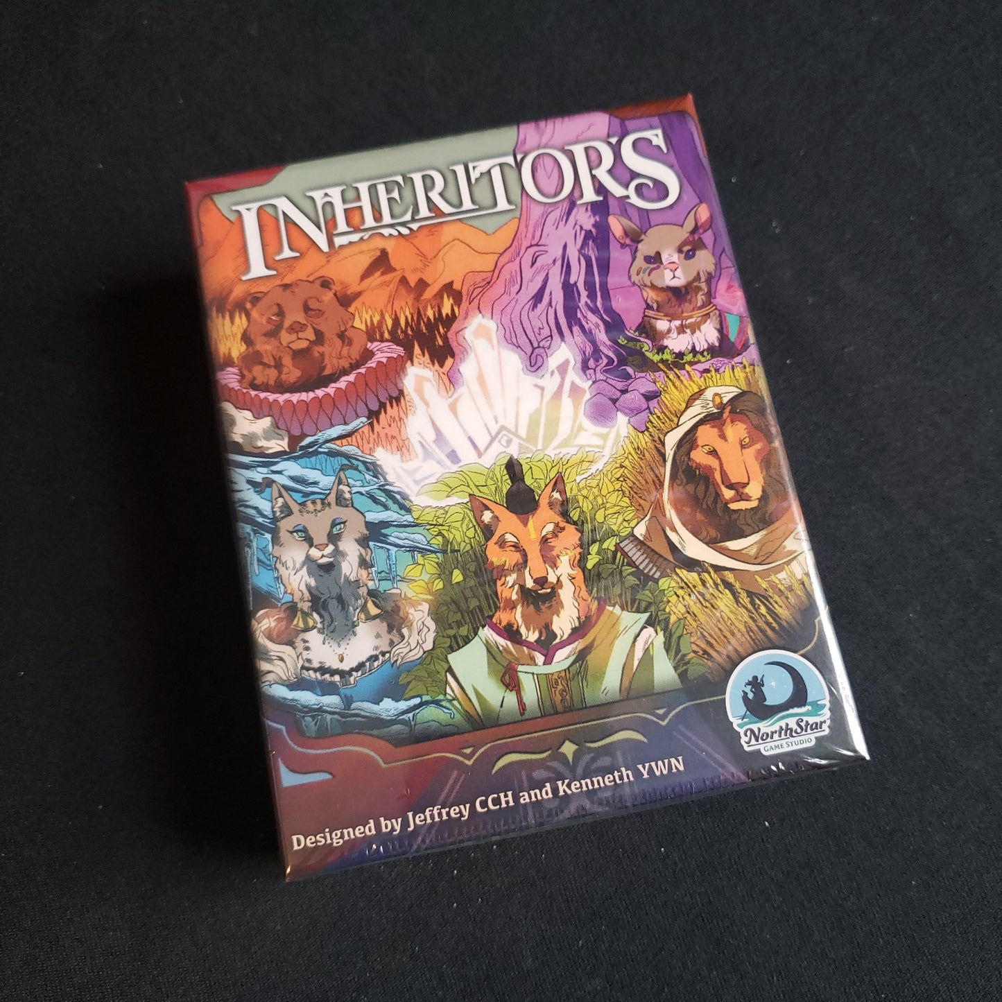 Image shows the front cover of the box of the Inheritors card game