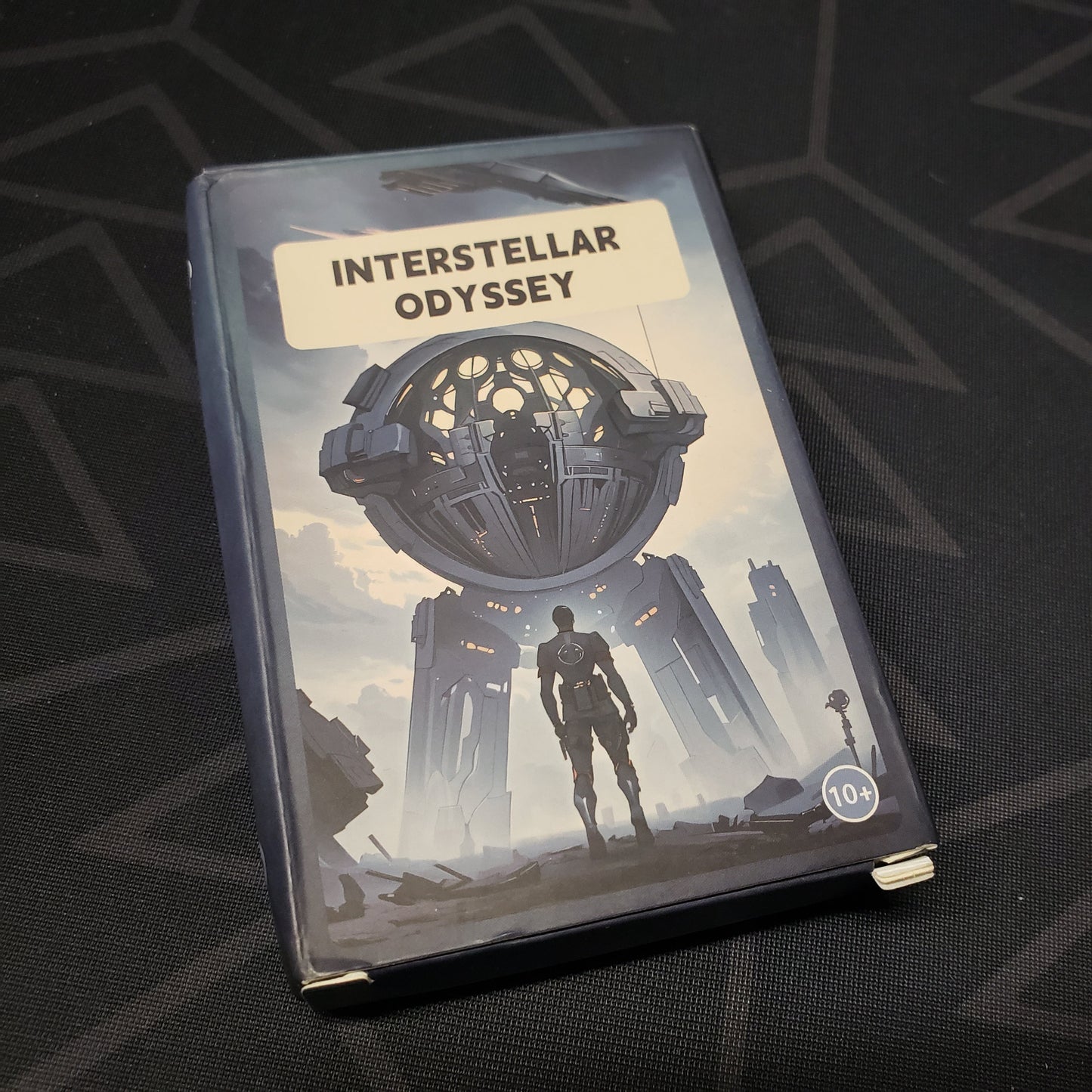 Image shows the front cover of the box for the Interstellar Odyssey board game