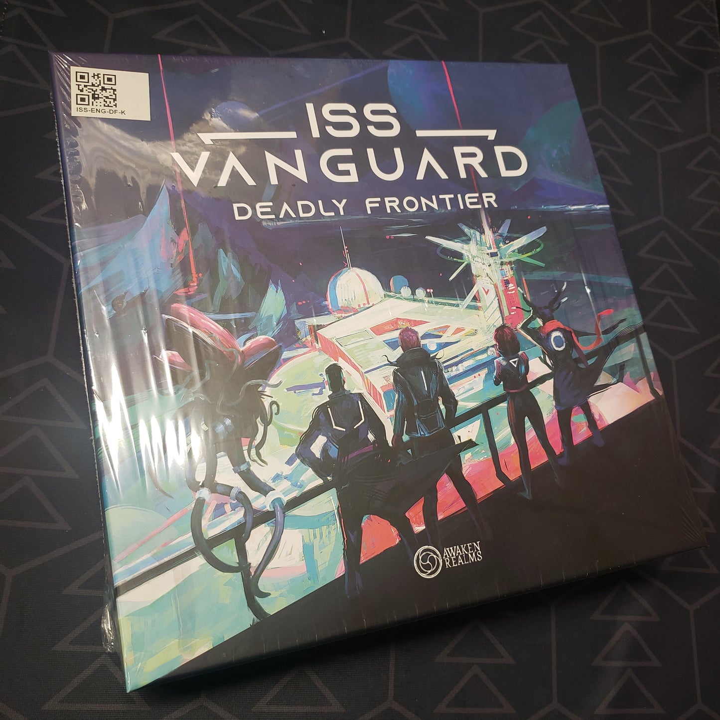Image shows the front cover of the box of the Deadly Frontier expansion for the board game ISS Vanguard