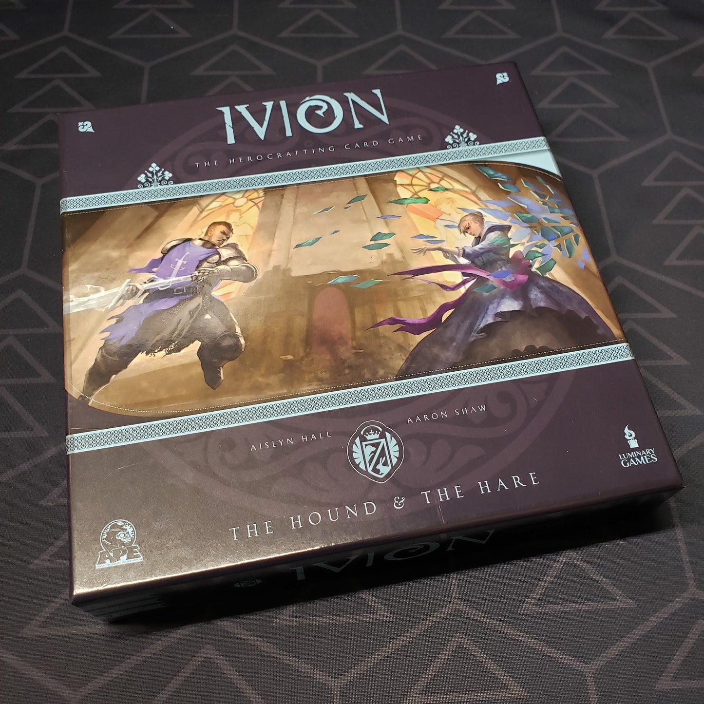 Image shows the front cover of the box for the Ivion: The Hound & The Hare card game