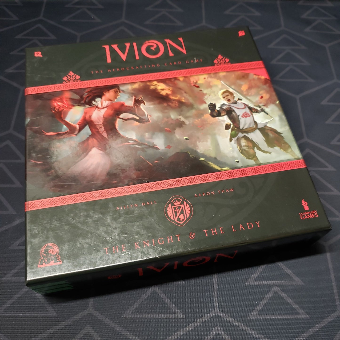 Image shows the front cover of the box for the Ivion: The Knight & The Lady card game