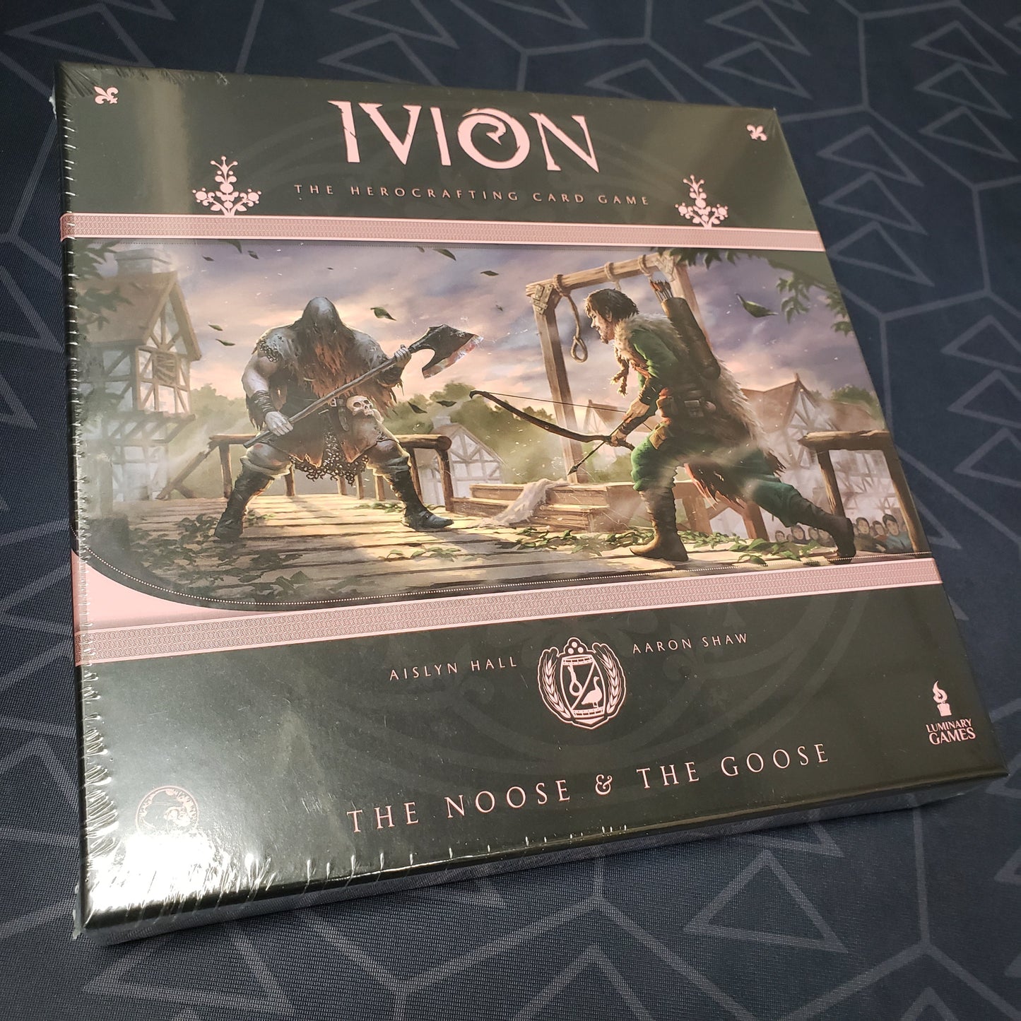 Image shows the front cover of the box for the card game Ivion: The Noose and The Goose
