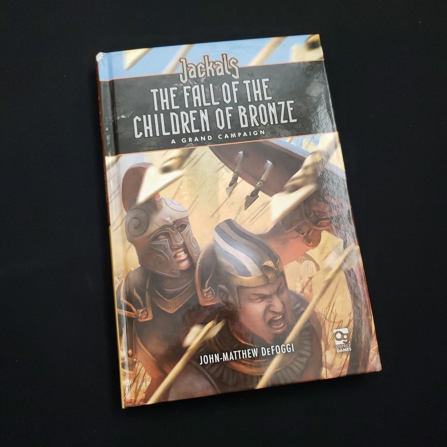 Image shows the front cover of the Fall of the Children of Bronze book for the Jackals roleplaying game