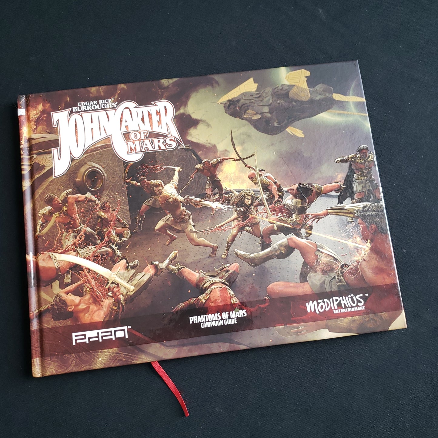 Image shows the front cover of the Phantoms of Mars Campaign Guide book for the John Carter of Mars roleplaying game