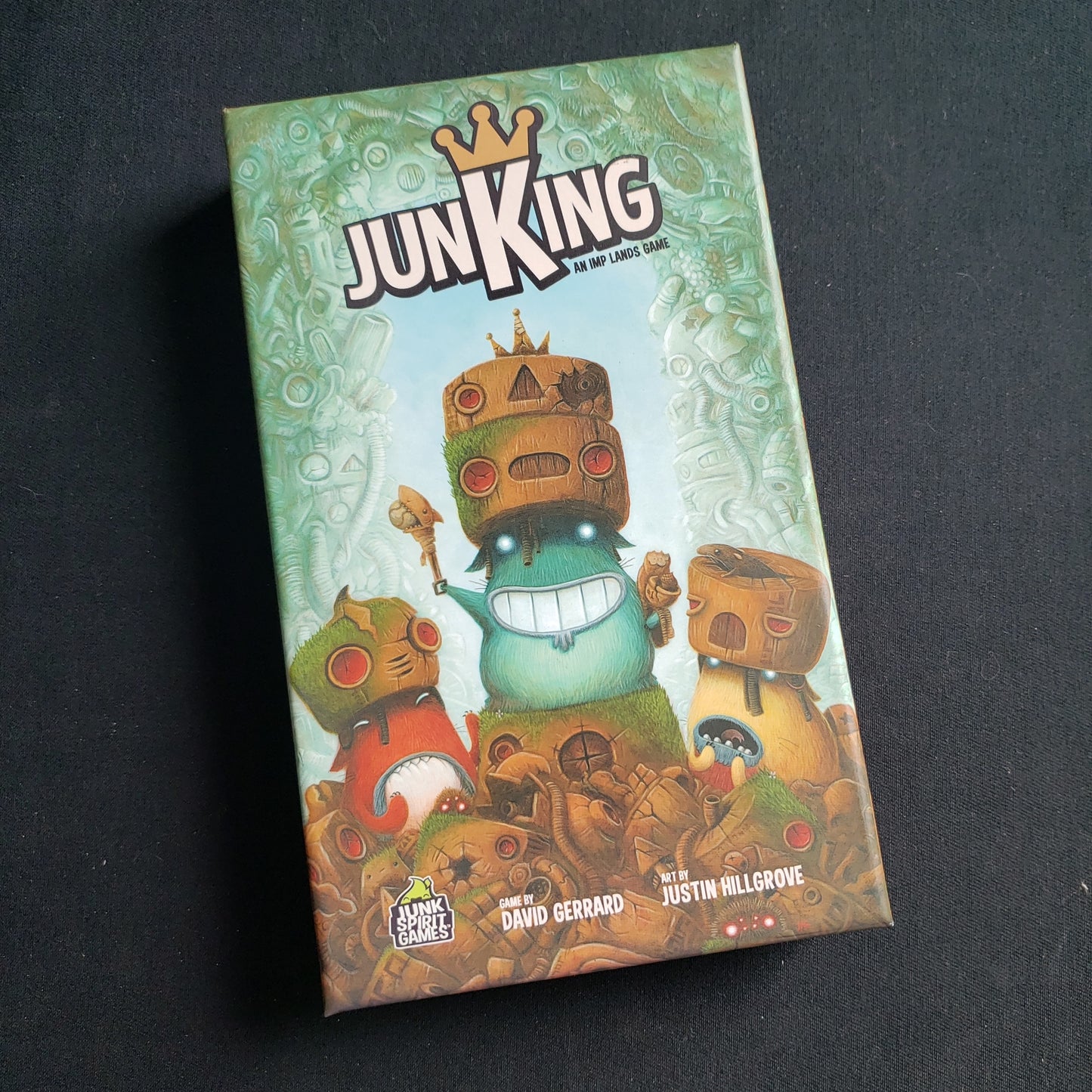 Image shows the front cover of the box of the JunKing card game