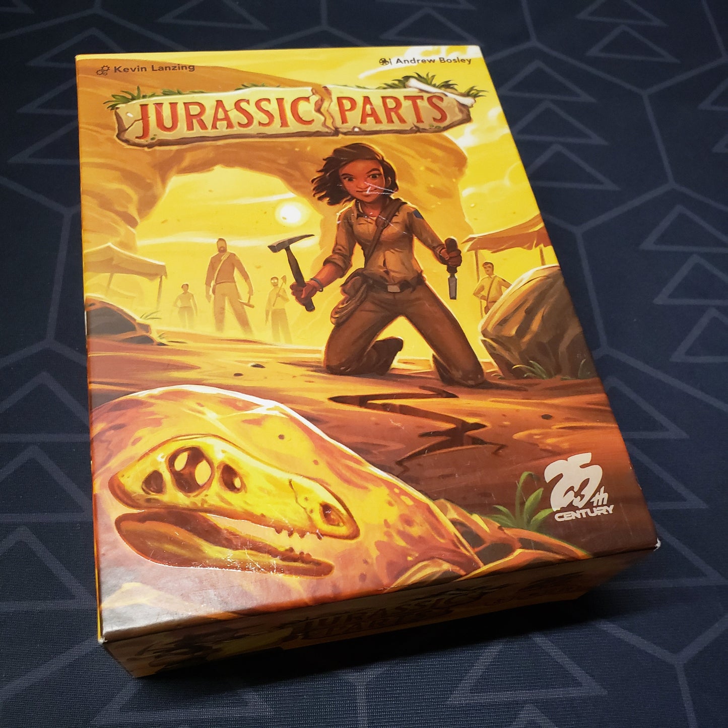 Image shows the front cover of the box for the Jurassic Parts board game