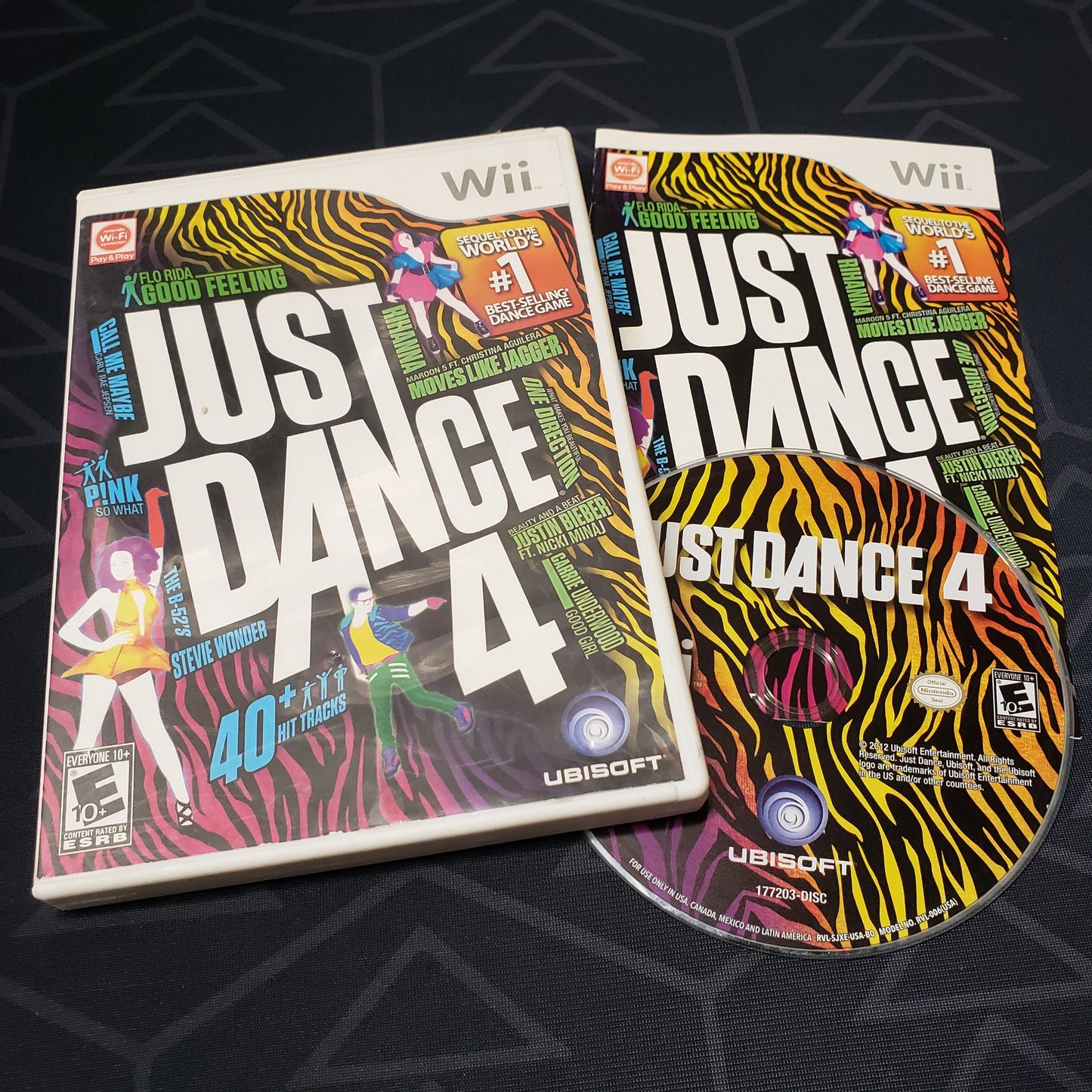Image shows the case, manual & disc for the video game Just Dance 4 for Nintendo Wii