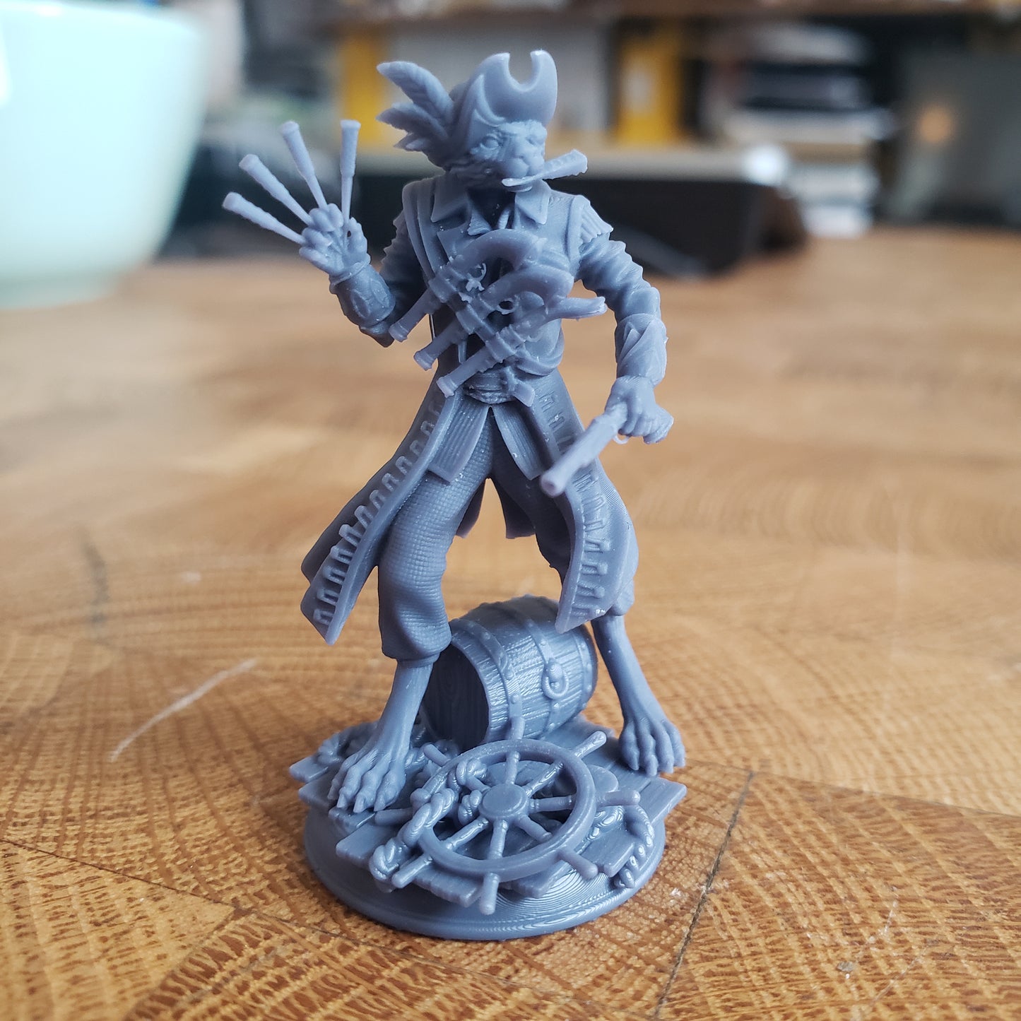 Image is a photo of a 3D printed catfolk pirate gaming miniature printed in-house at All Systems Go