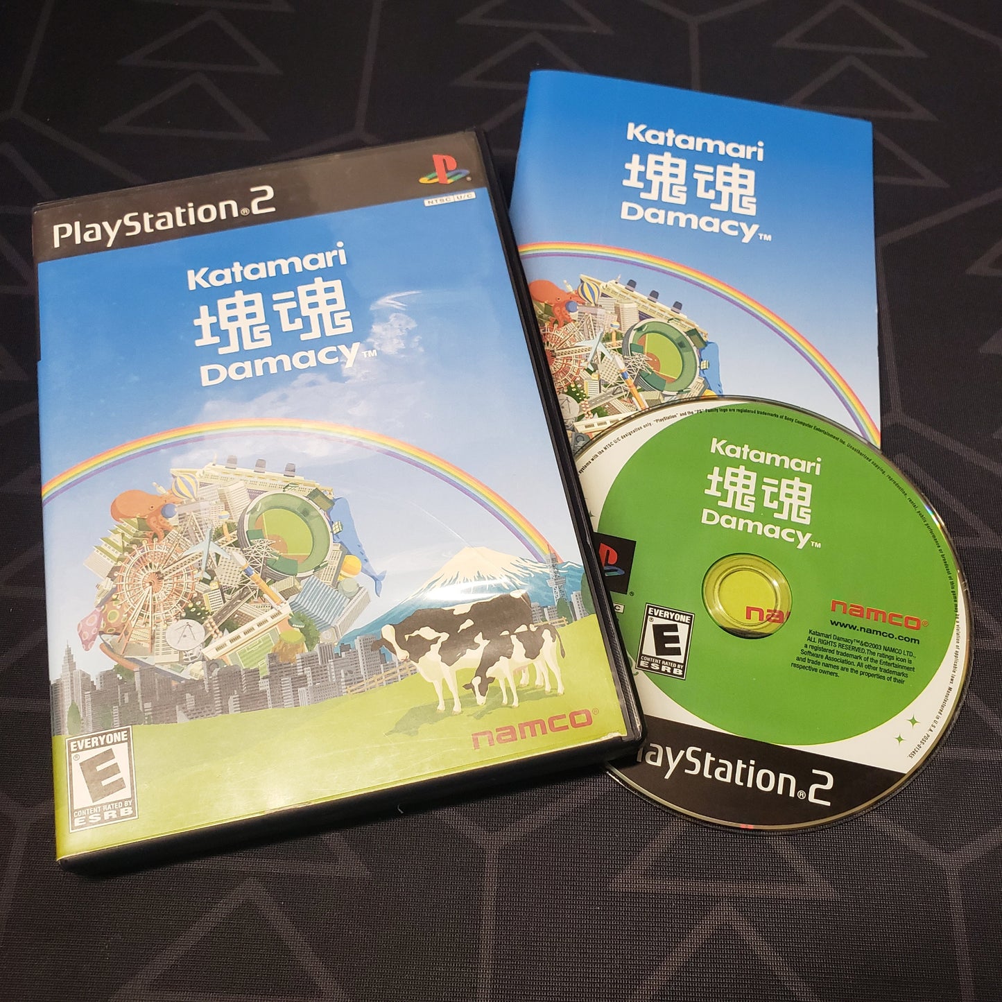 Image shows the case, manual and disc for the video game Katamari Damacy for Playstation 2