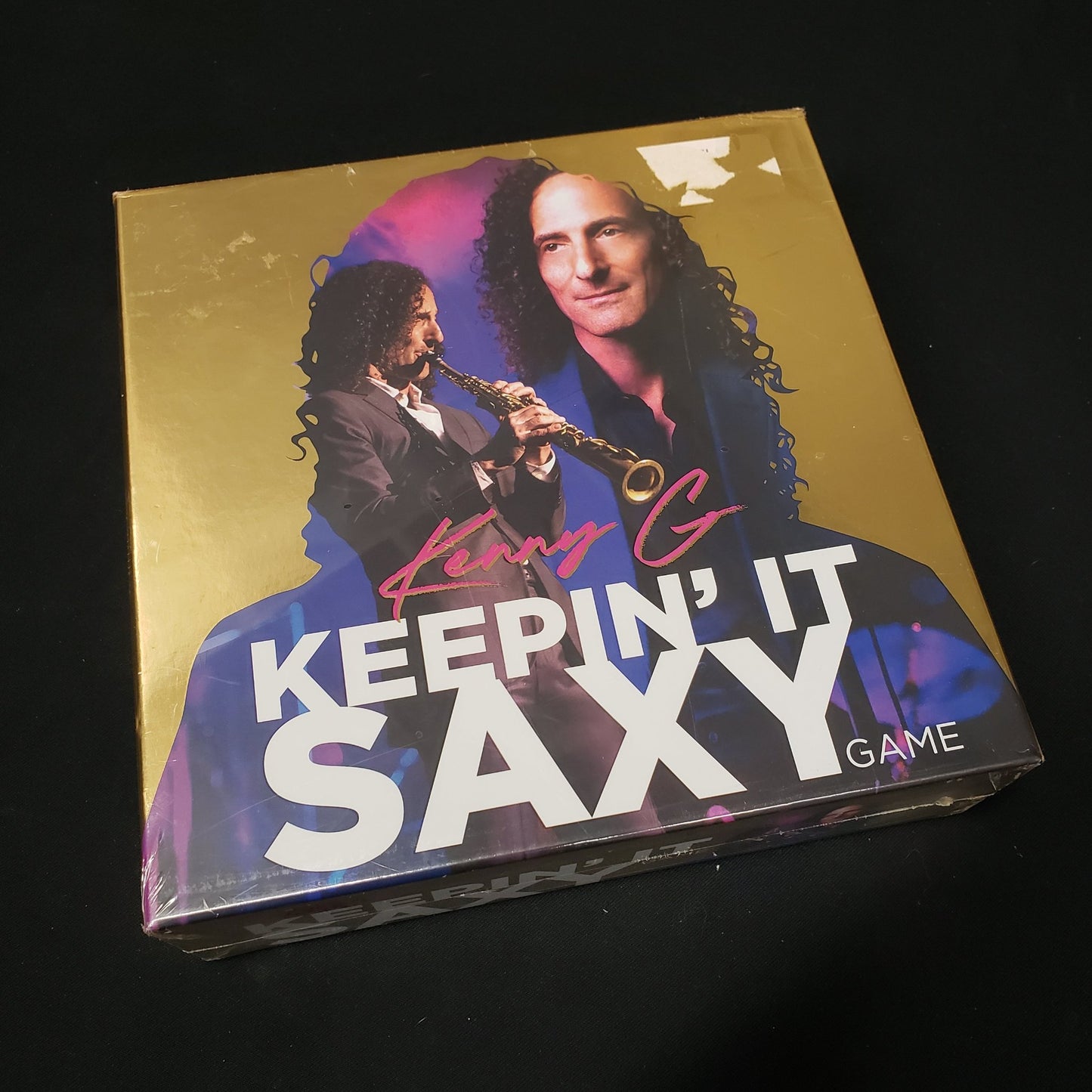 Image shows the front cover of the box of the Kenny G: Keepin' It Saxy board game