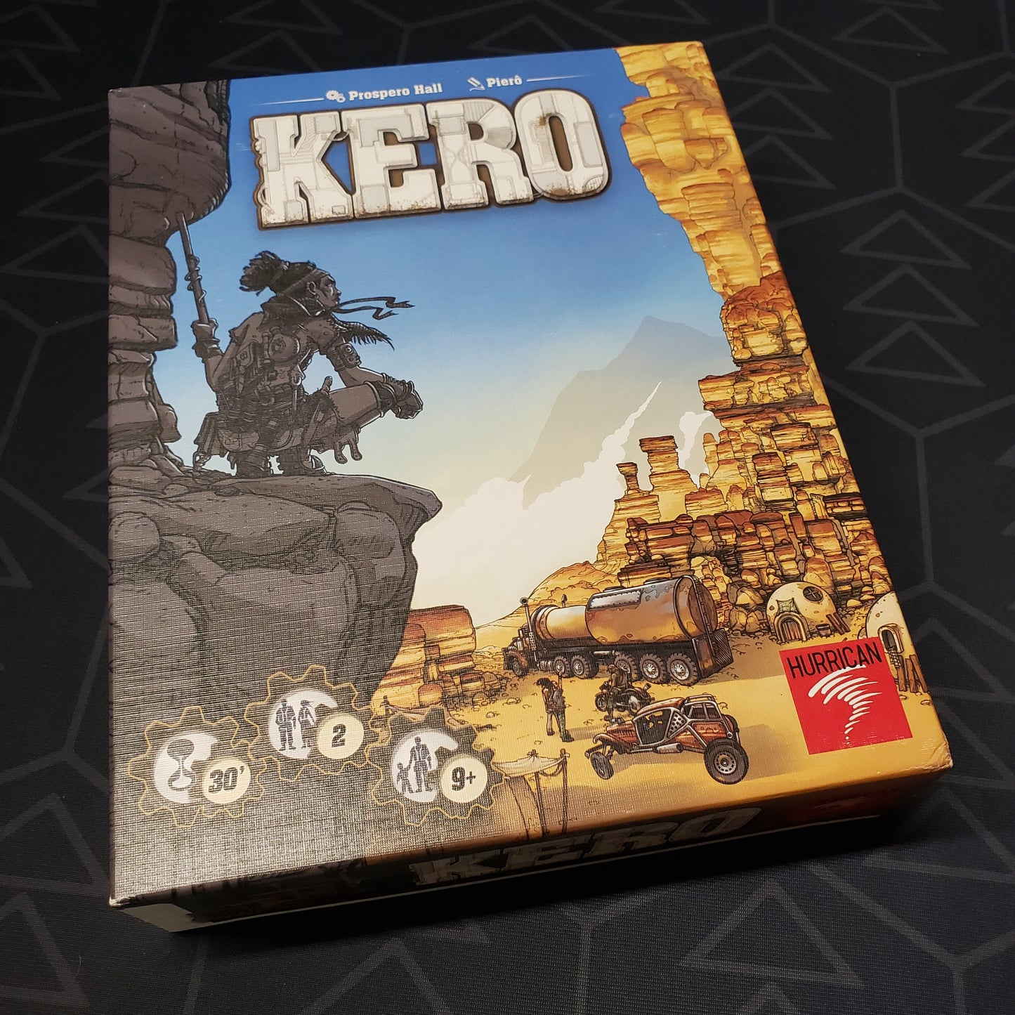 Image shows the front cover of the box of the Kero board game