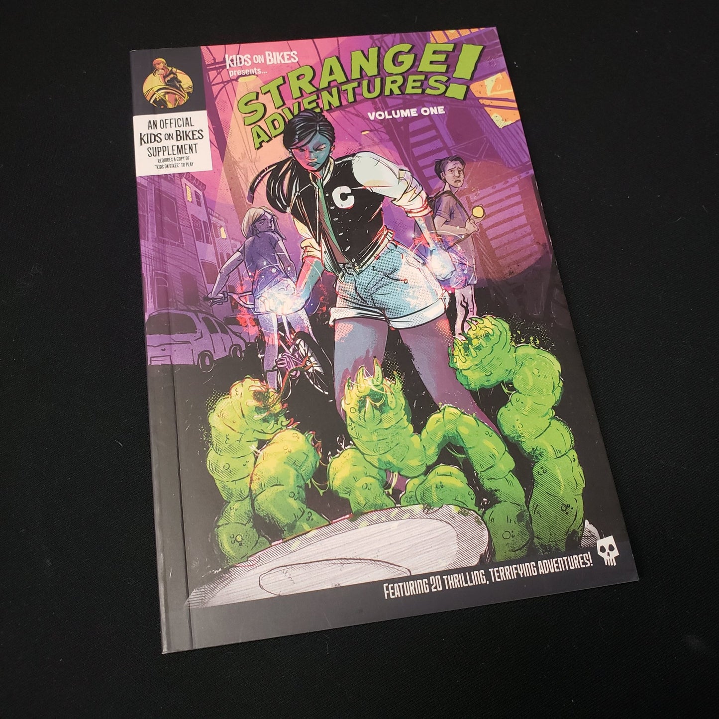 Image shows the front cover of the Strange Adventures! Vol. 1 book for the roleplaying game Kids on Bikes
