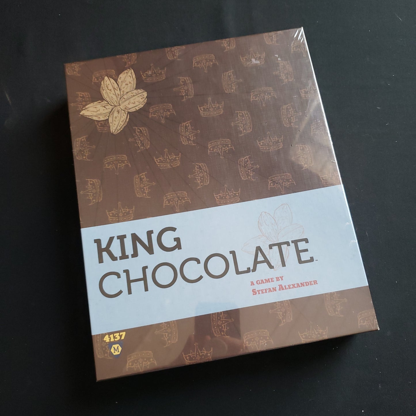 Image shows the front cover of the box of the King Chocolate board game