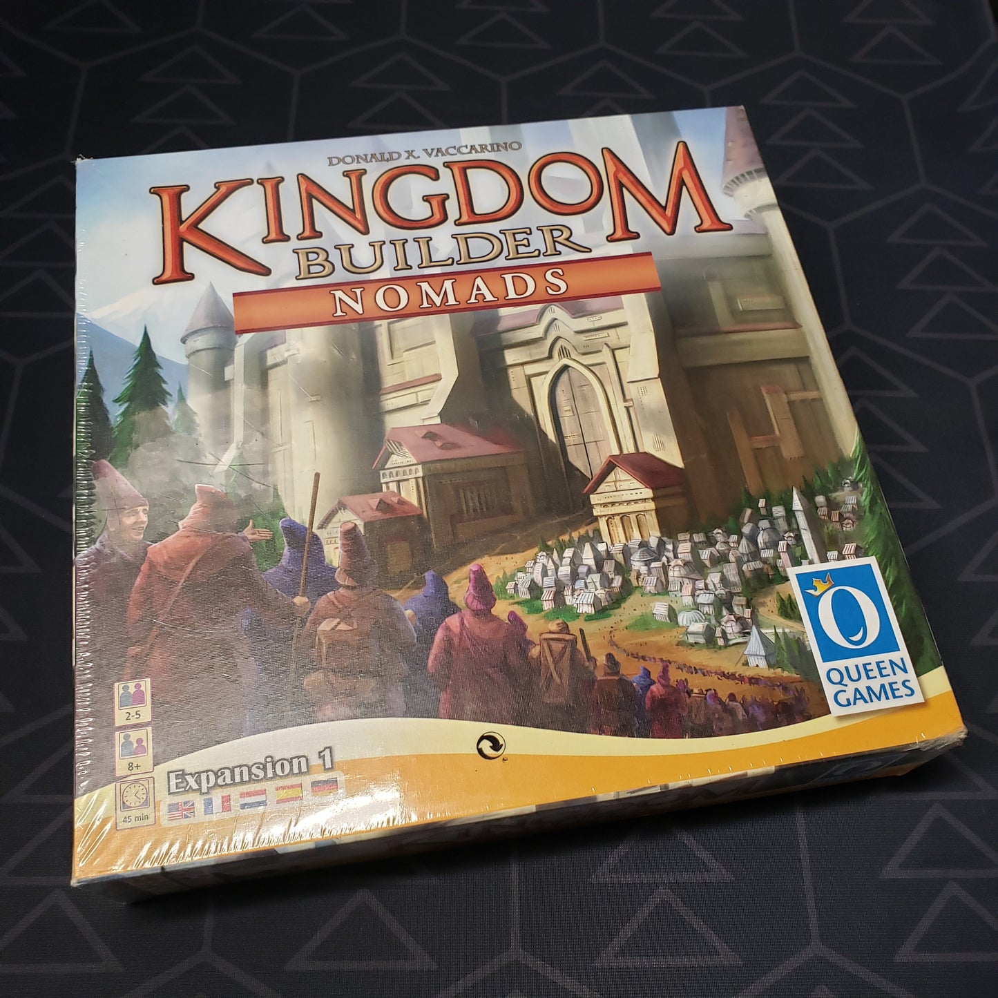 Image shows the front cover of the box of the Nomads expansion for the board game Kingdom Builder