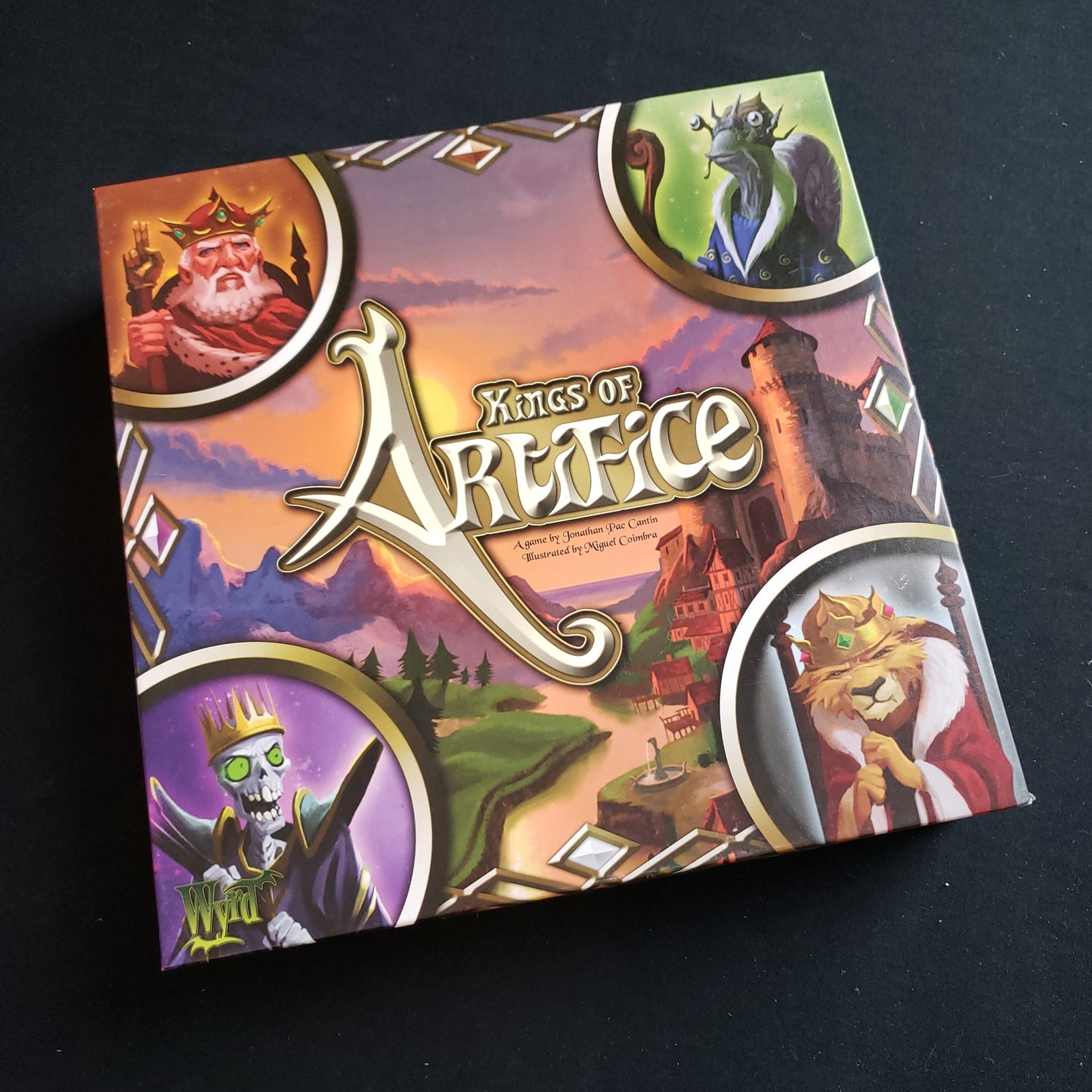Image shows the front cover of the box of the Kings of Artifice board game