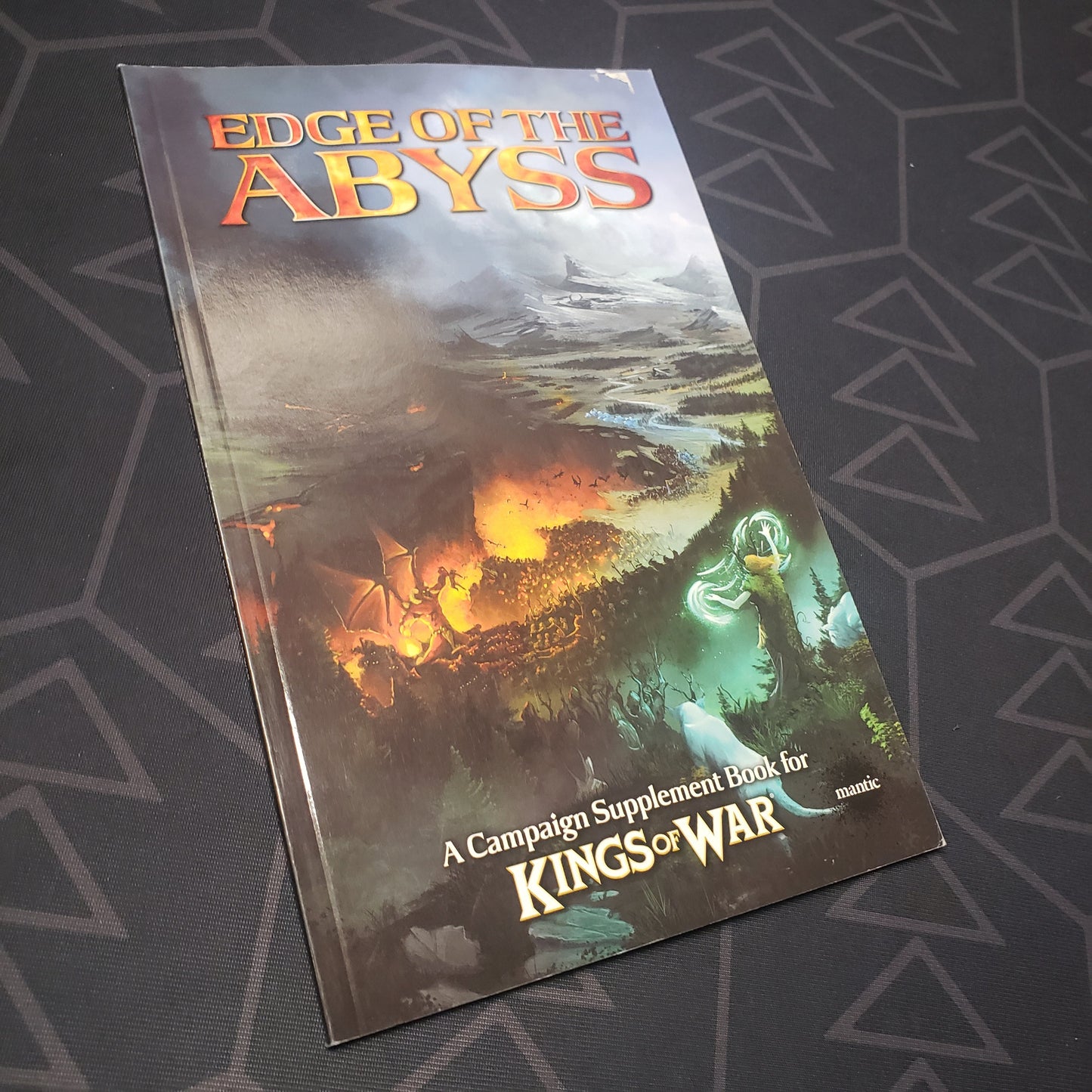 Image shows the front cover of the Kings of War 2E: Edge of the Abyss wargaming book