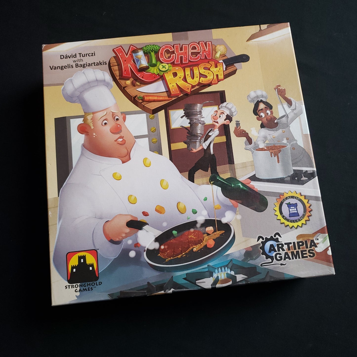 Image shows the front cover of the box of the Kitchen Rush board game