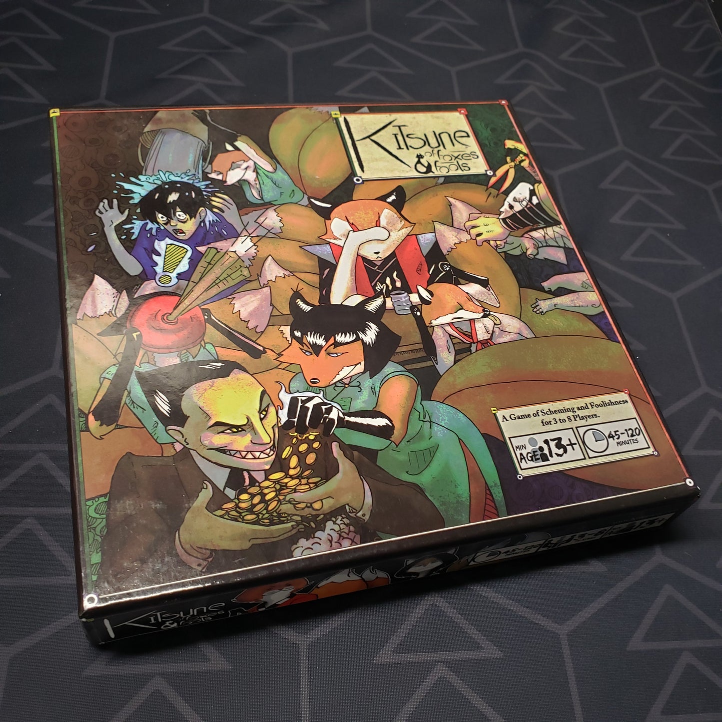 Image shows the front cover of the box for the Kitsune: Of Foxes & Fools card game