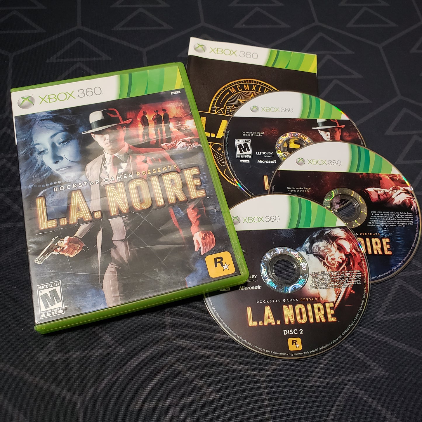 Image shows the case, manual and three discs for the video game L.A. Noire for Xbox 360