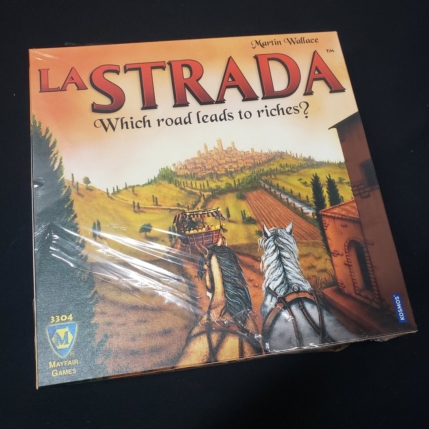 Image shows the front cover of the box of the La Strada board game