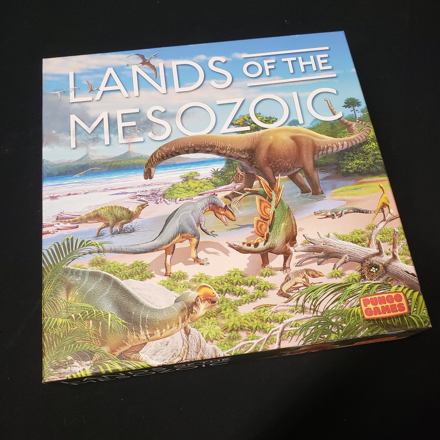 Image shows the front cover of the box of the Lands of the Mesozoic board game