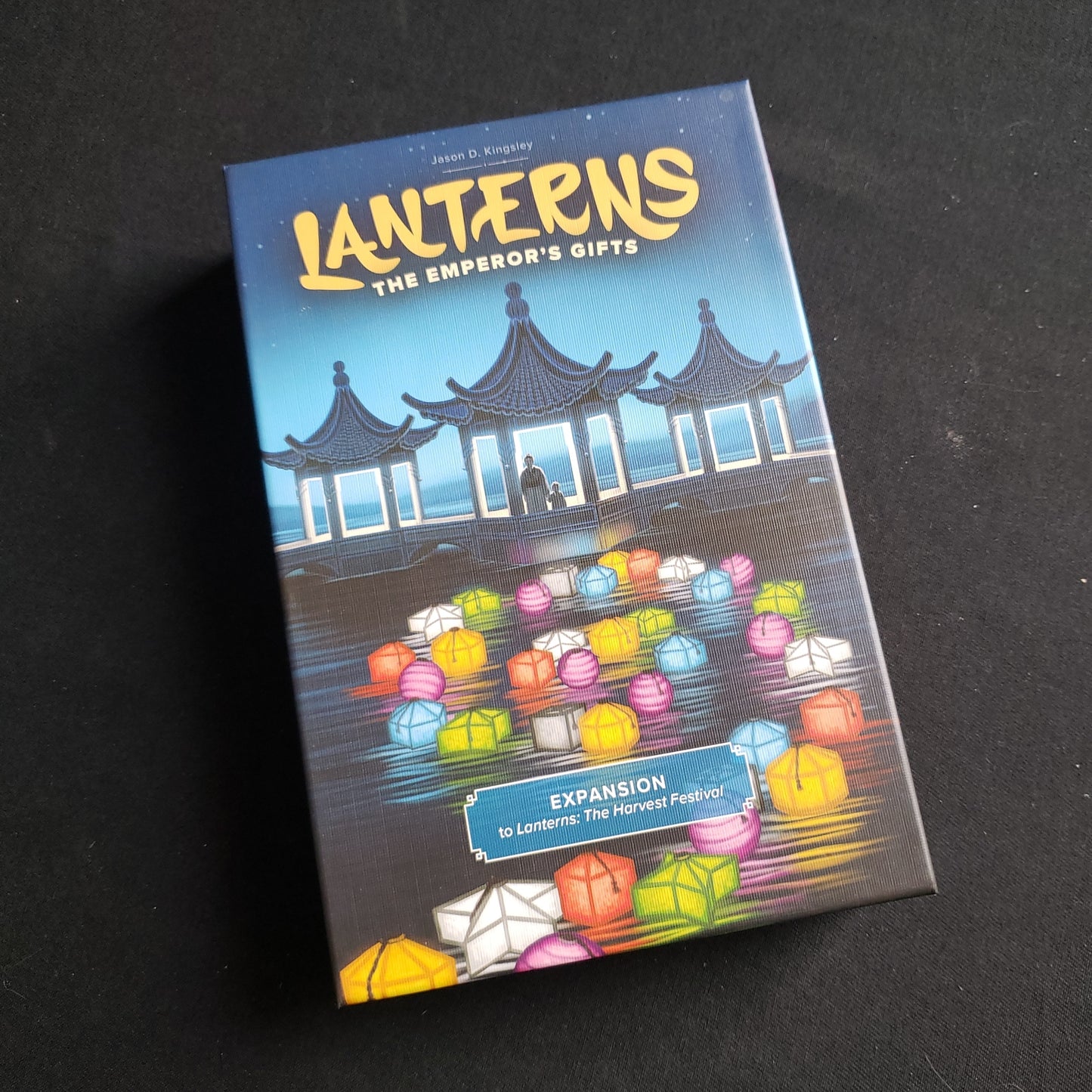Image shows the front of the box for the Emperor's Gifts Expansion for the Lanterns: The Harvest Festival board game