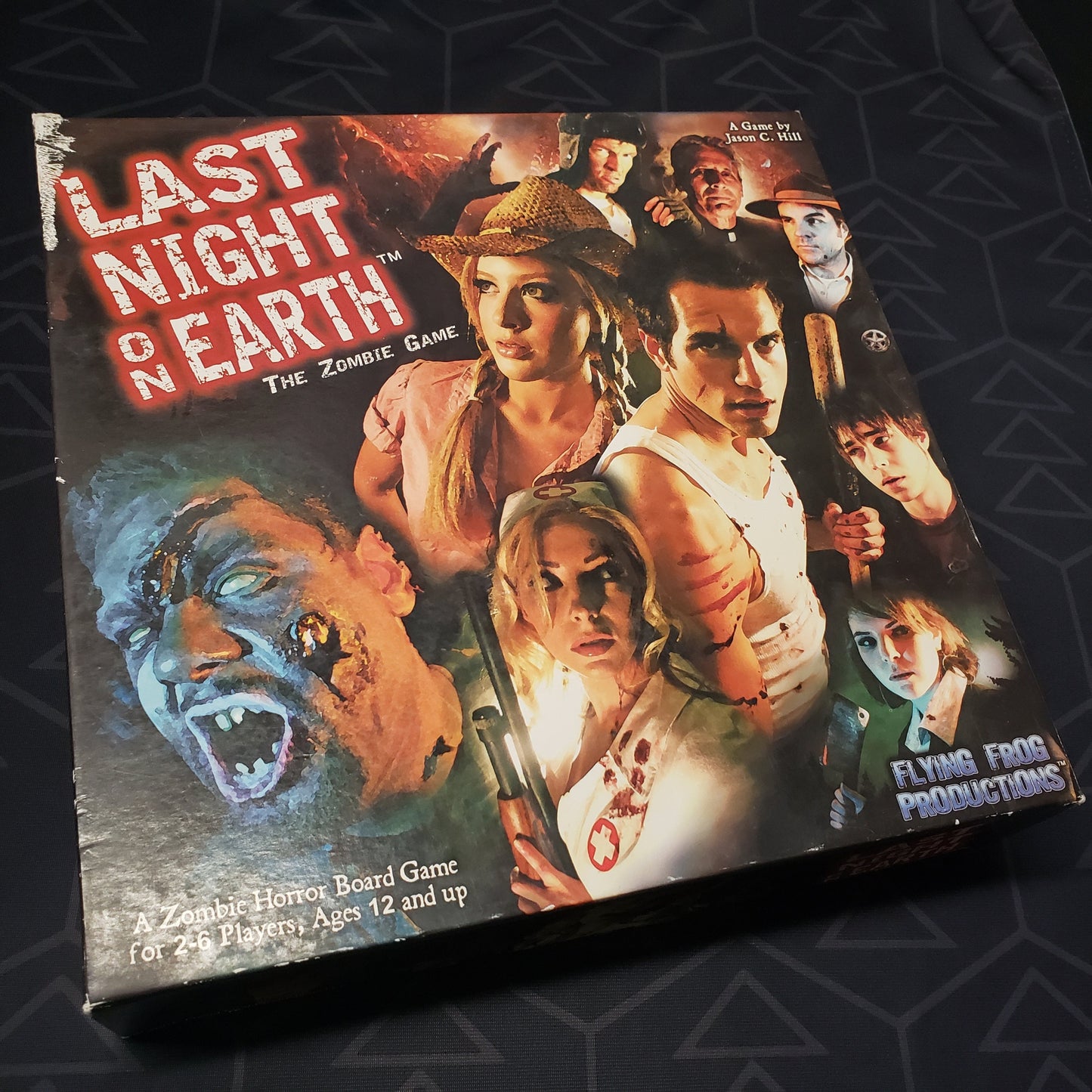 Image shows the front cover of the box of the Last Night on Earth board game