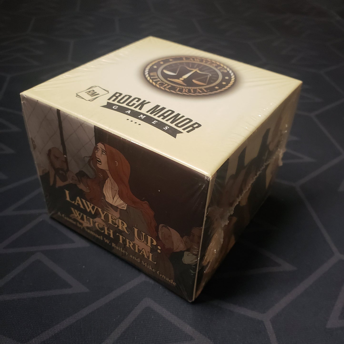 Image shows the front cover of the box of the Witch Trial expansion for the card game Lawyer Up