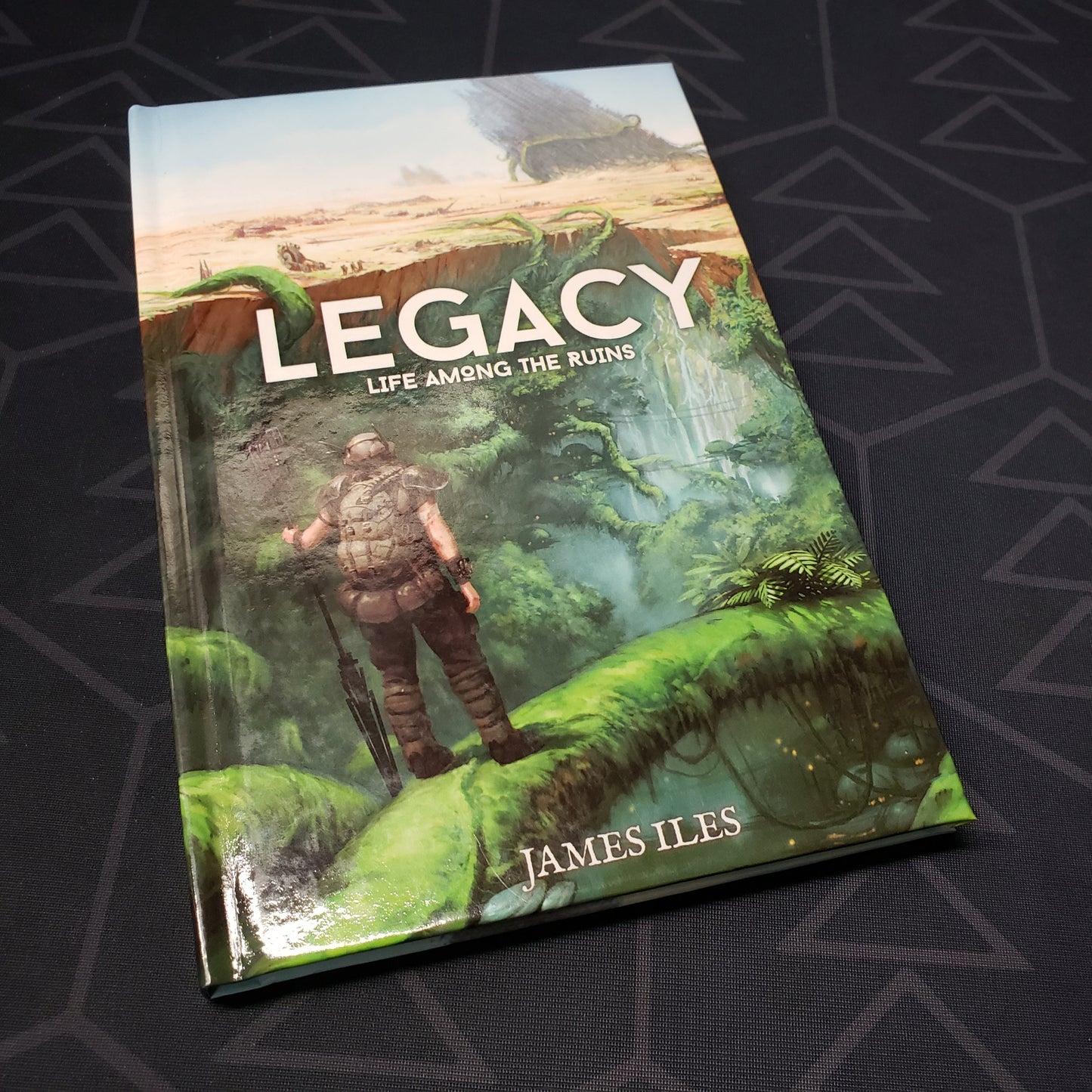 Image shows the front cover of the core rulebook for the roleplaying game Legacy: Life Among the Ruins