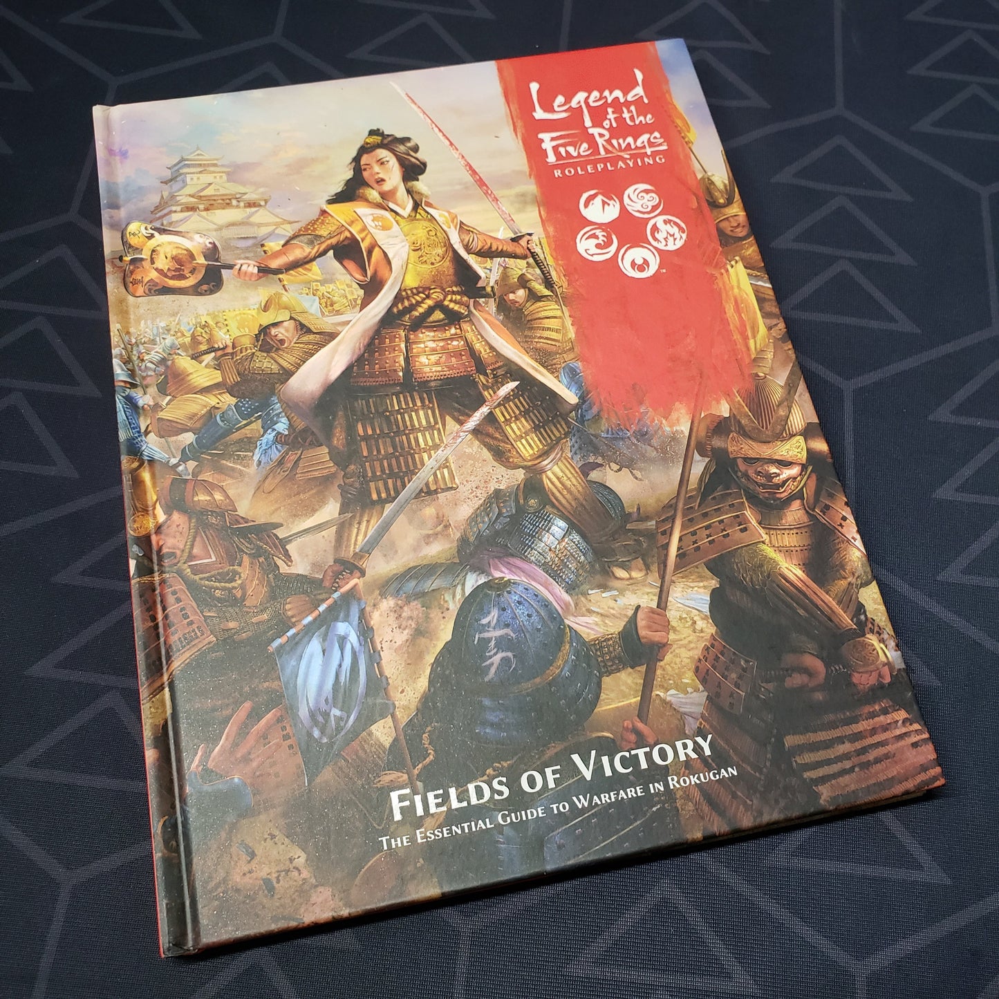 Image shows the front cover of the Fields of Victory book for the roleplaying game Legend of the Five Rings: Fifth Edition