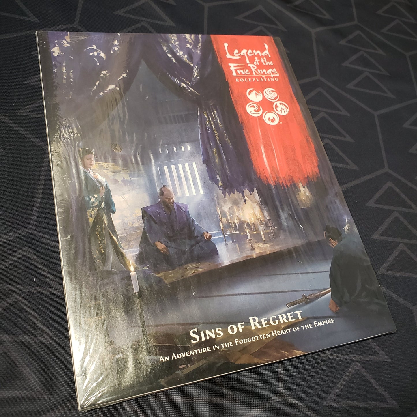 Image shows the front cover of the Sins of Regret book for the roleplaying game Legend of the Five Rings: Fifth Edition